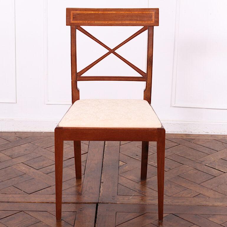 Set of eight English inlaid mahogany Sheraton style dining chairs of simple form, the square backs with ‘X’ splat and inlaid banded top rails.



  