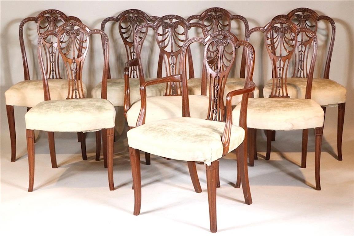 Set of Eight George III Carved Mahogany Dining Chairs.  Early 19th Century Hepplewhite with wonderfully caved back and great proportion.  Saddle seats for the ultimate of comfort.  Two arm, six sides.  Sturdy 

