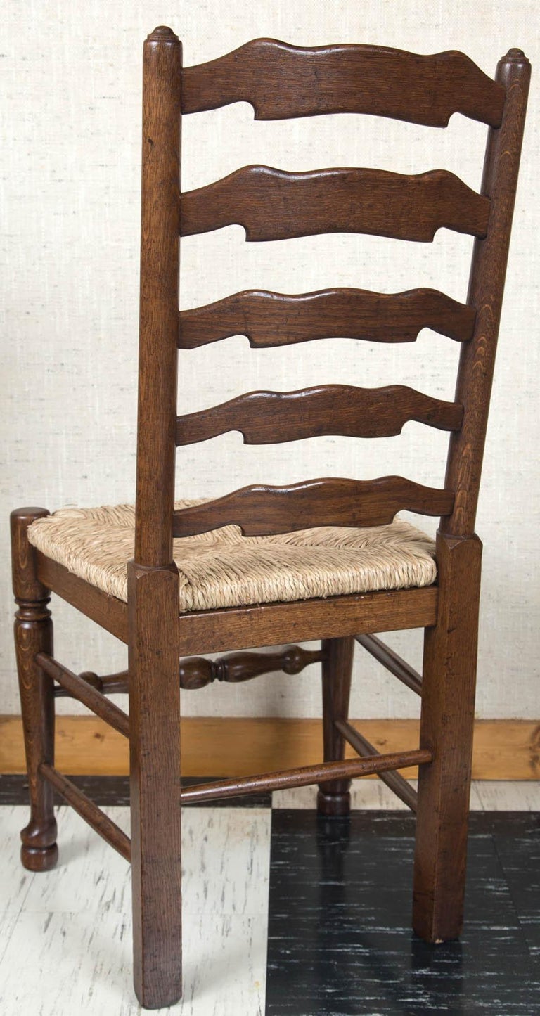 Set of Eight English Oak Wavy Ladder Back Chairs with Rush Seats For