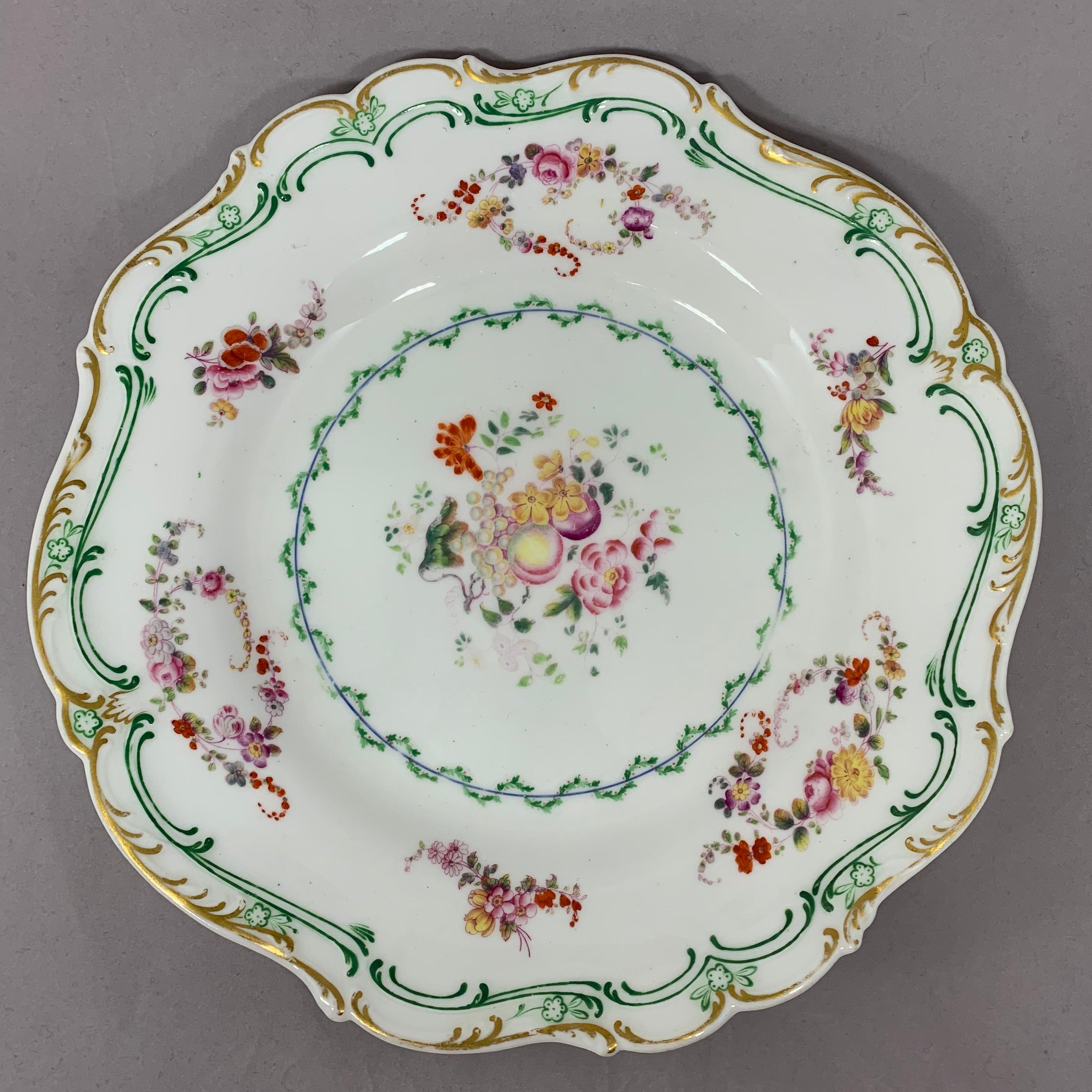Set of eight green and gilt banded floral plates. Hand painted plates with floral swags and fruits with gilt rim. England, circa 1840s
Dimensions: 9