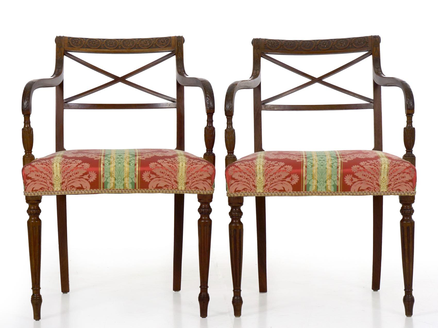 An exquisite set of eight dining chairs from the first quarter of the 19th century, they are crafted of solid and dense grained mahogany throughout all primary surfaces. Note the crisply carved crest rails with motifs of intertwined infinite-rings