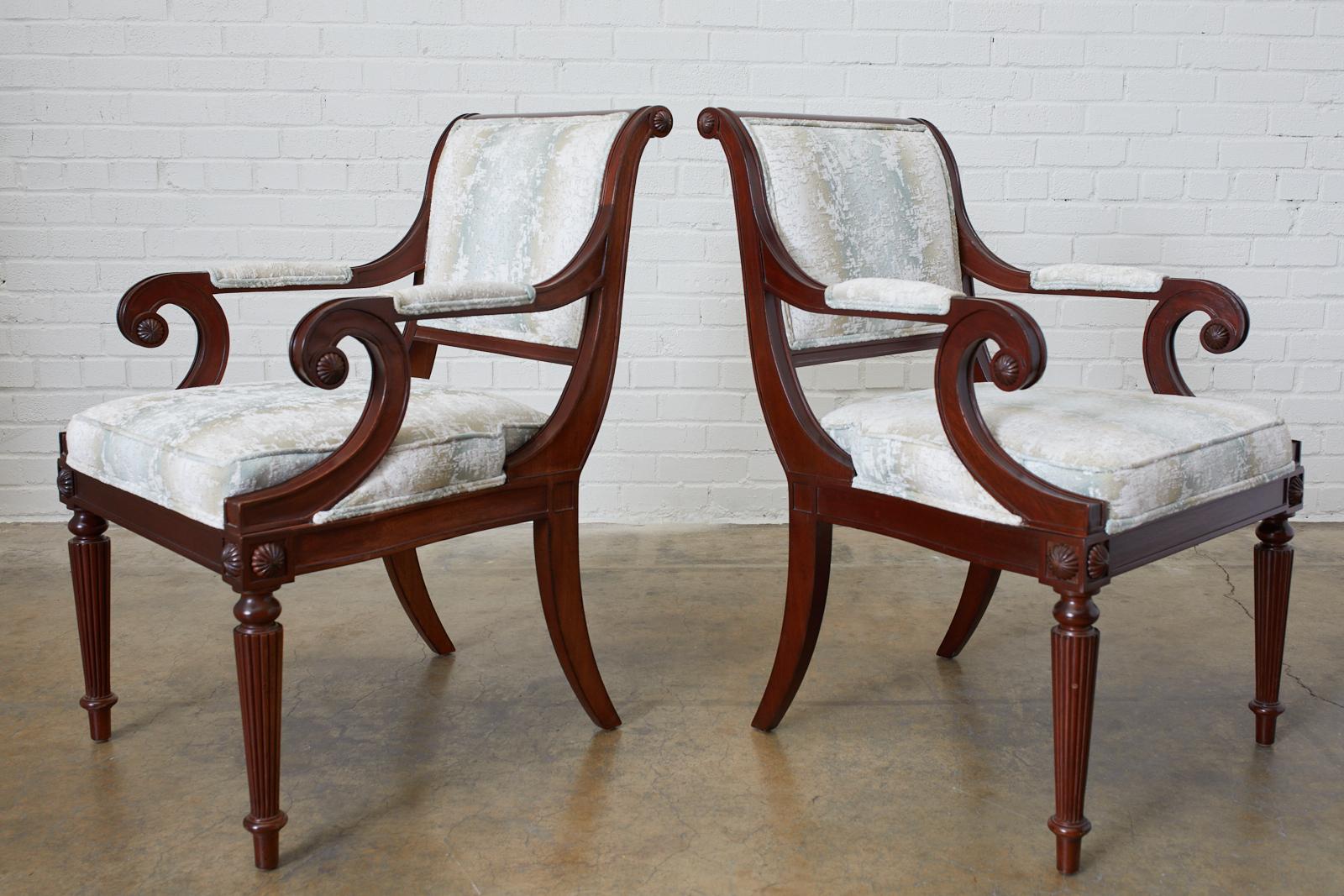 Distinctive set of eight mahogany dining chairs made in the English Regency taste. Iconic profiles featuring a scrolled back that gracefully curves down to klismos rear legs. The set consists of two armchairs and six side chairs measuring 22 inches