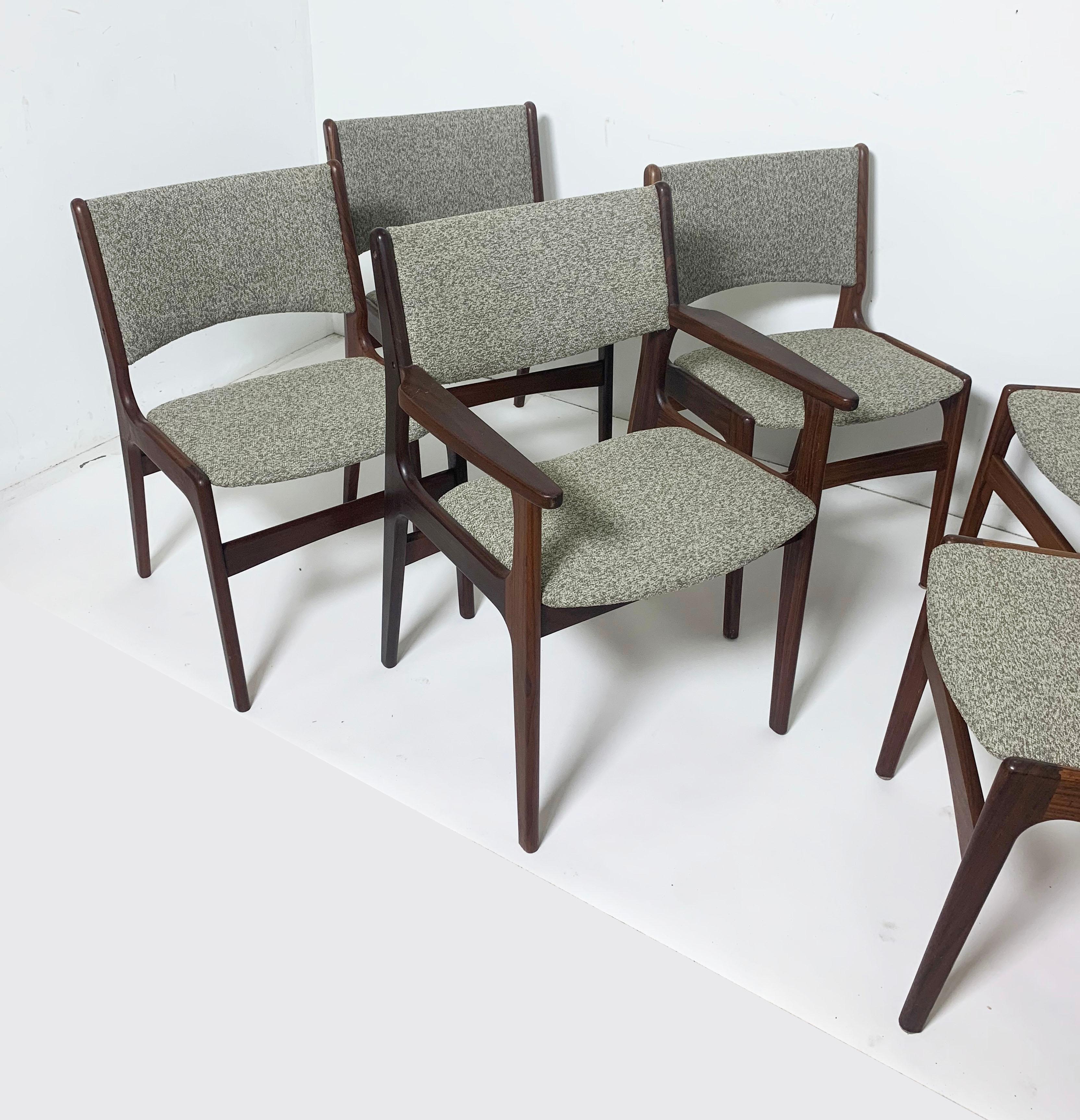 Set of eight Danish teak dining chairs by Erik Buch, circa 1960s. This newly upholstered set in teak consists of 7 sides and one arm.

Arm chair measures: 23.25