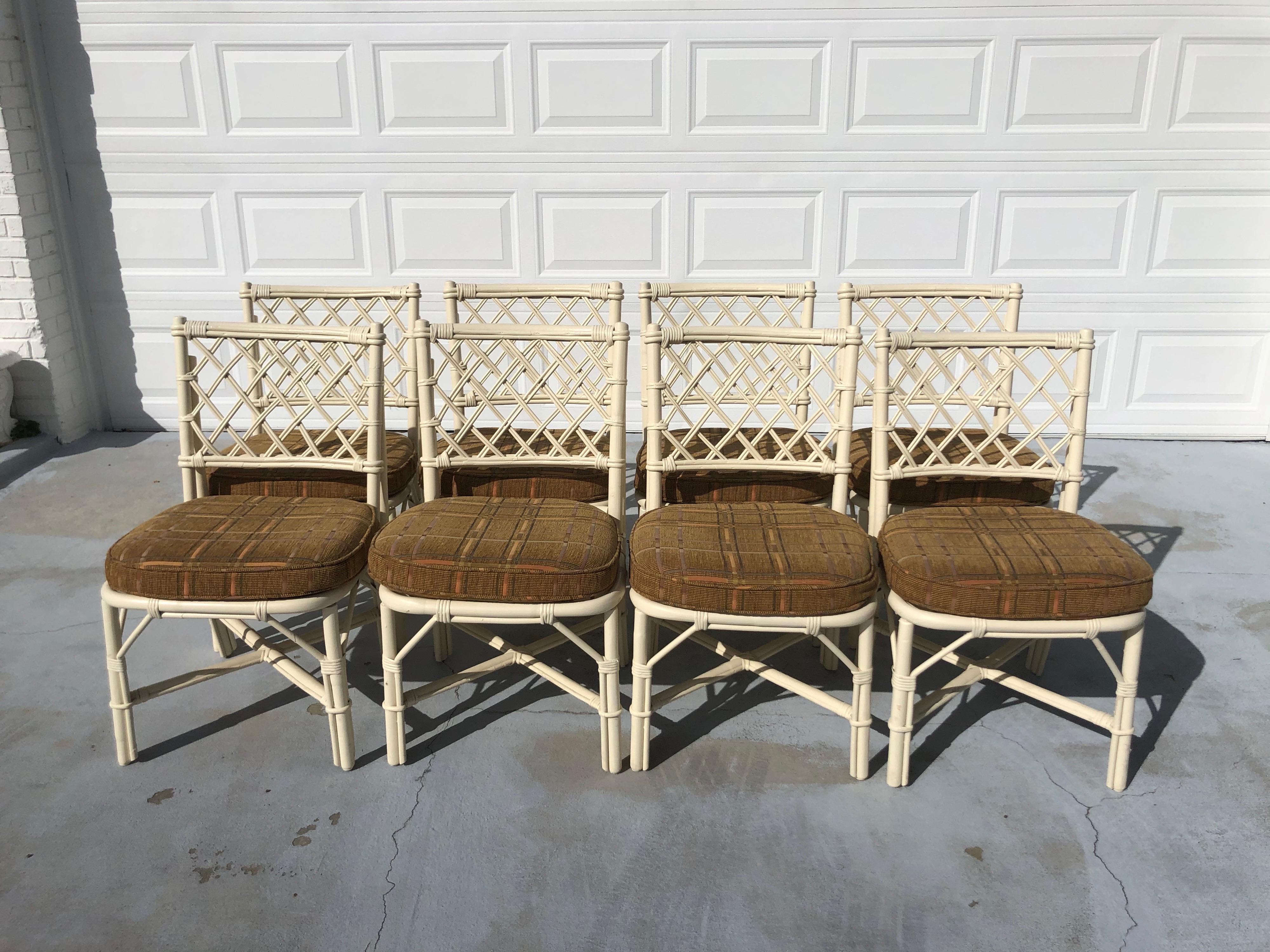 Set of eight faux bamboo dining chairs with cushions. Fabulous boho chic design in the style of Barbara Barry for McGuire. These chairs have a painted off-white finish perfect for that coastal look. Chair pads are custom made and snap on and off.