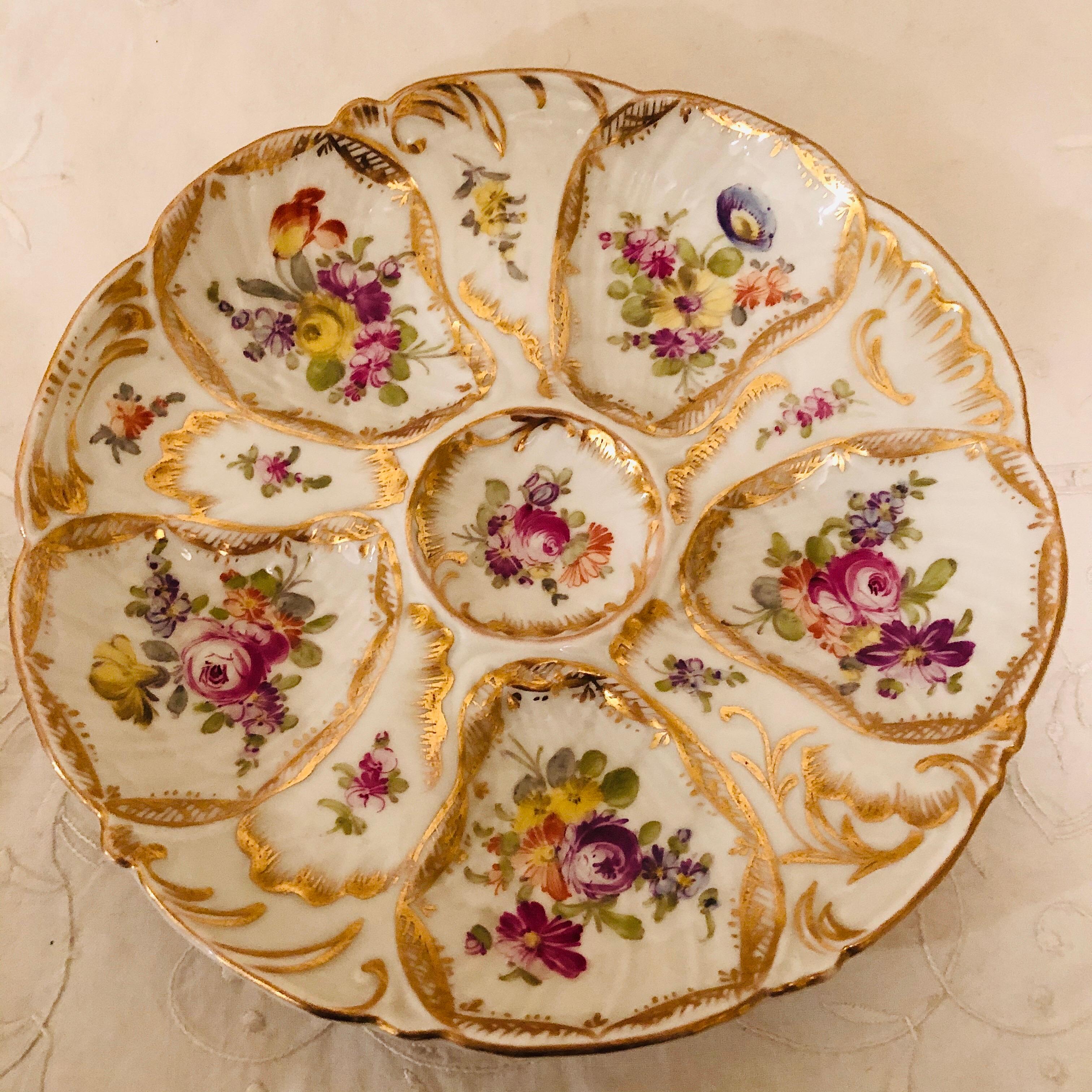 I want to present you with this rare set of eight Dresden fluted oyster plates, each painted differently with different sprays of flowers. These were designed by Franziska Hirsch at Dresden in the 1890s. Each oyster plate has five wells for oysters