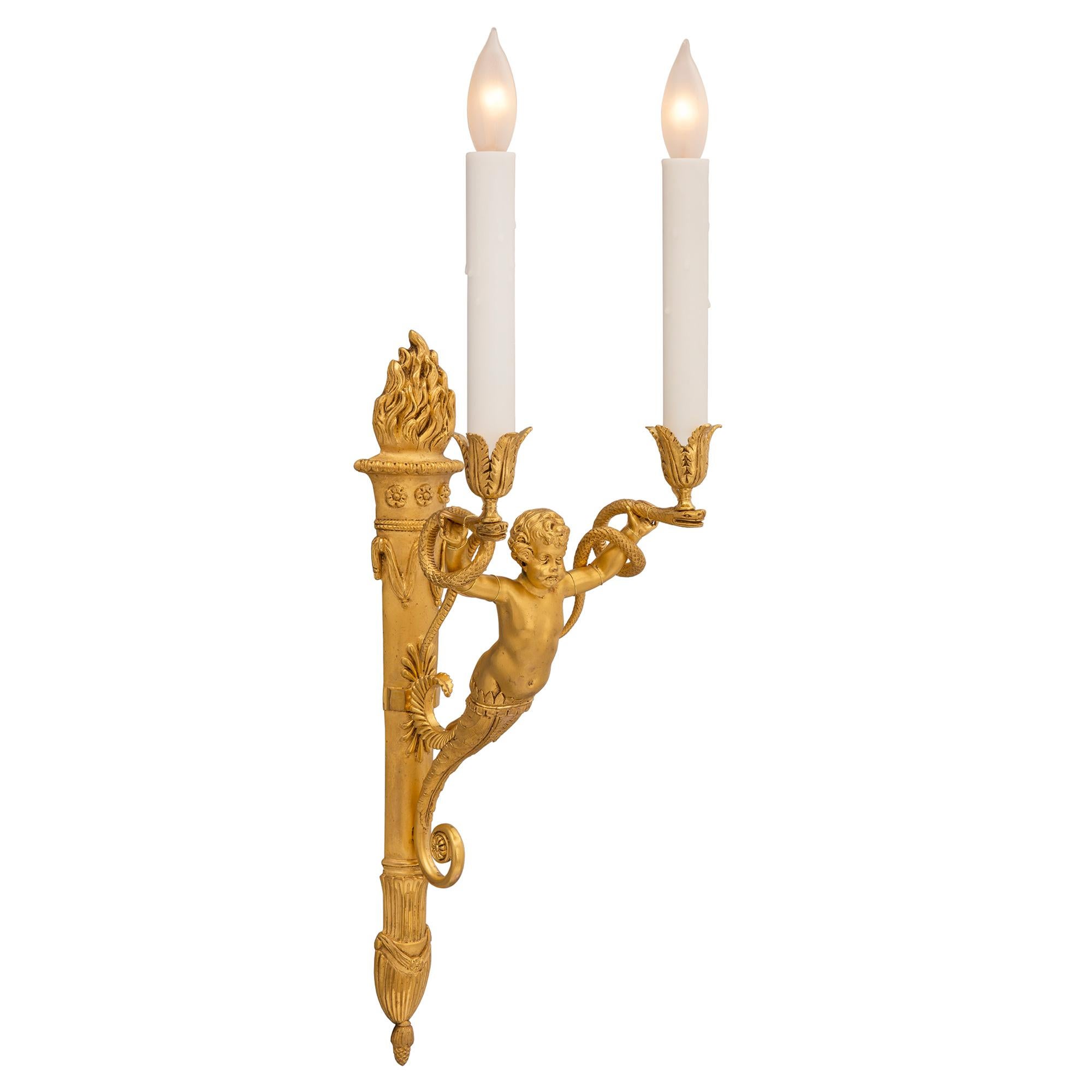 A charming and high quality complete set of eight French 19th century Neo-Classical ormolu two arm sconces, attributed to Pierre-Philippe Thomire. Each sconce is centered by an elegant tapered back plate in the shape of a quiver with a fine bottom