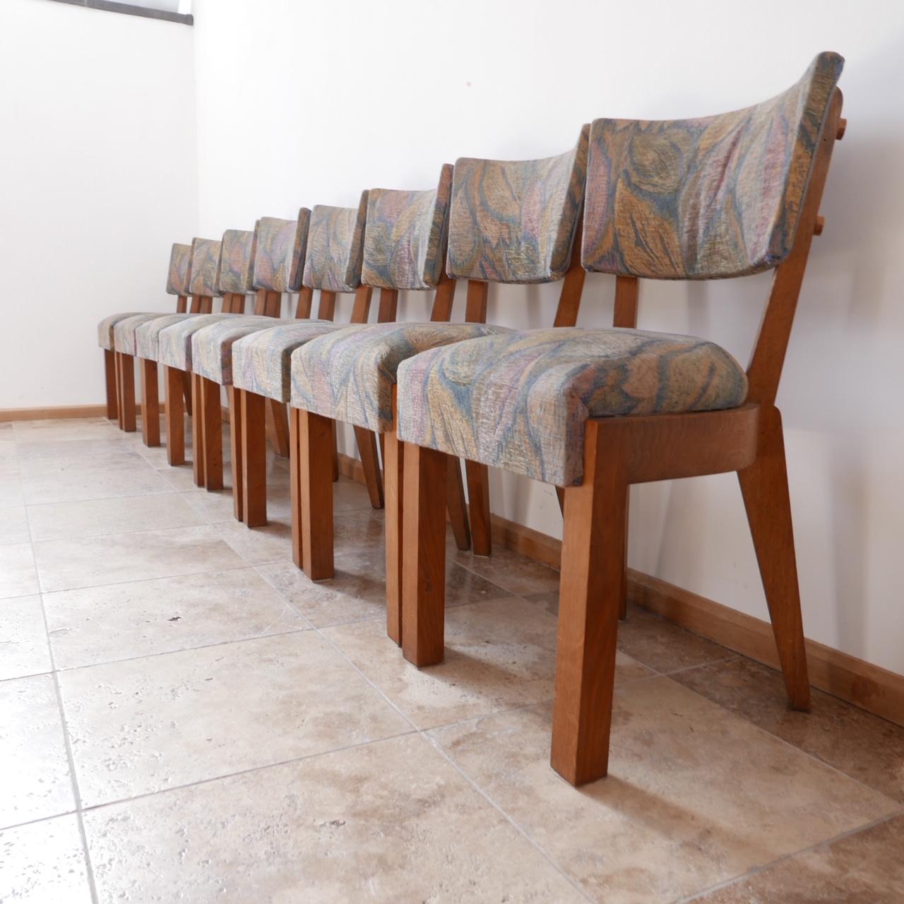A set of eight chunky heavy dining chairs attributed to Charles Dudouyt. 

Art deco style. 

France, c1940s. 

Solid oak and original upholstery, the upholstery has wear so wants updating which we can arrange if needed. 

Dimensions: 44 W x