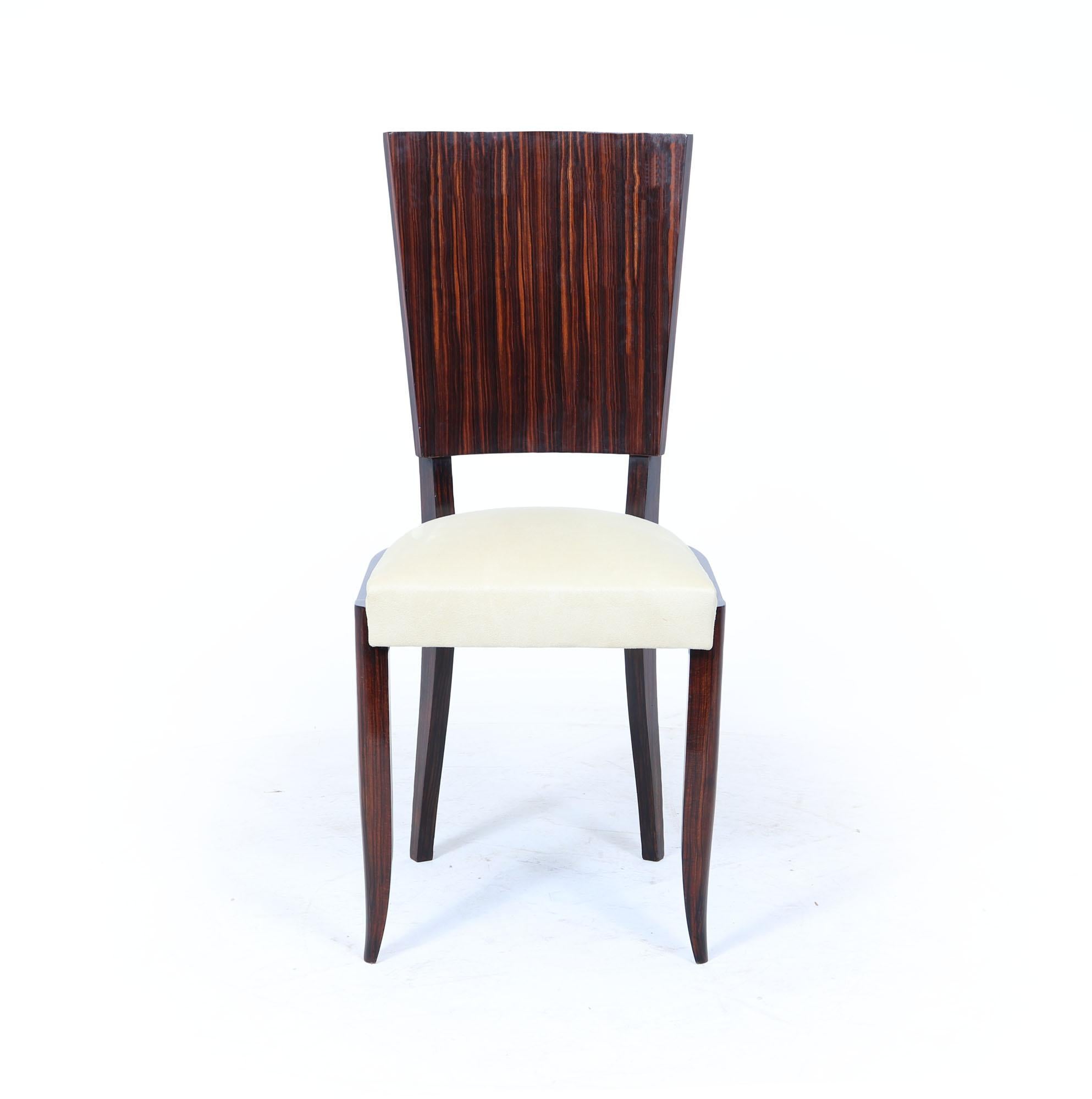French Art Deco Macassar Dining Chairs

A striking set of eight French Art Deco dining chairs, fully restored and reupholstered to showcase their original elegance. Crafted in a mix of solid and simulated Macassar ebony, the chairs feature beautiful