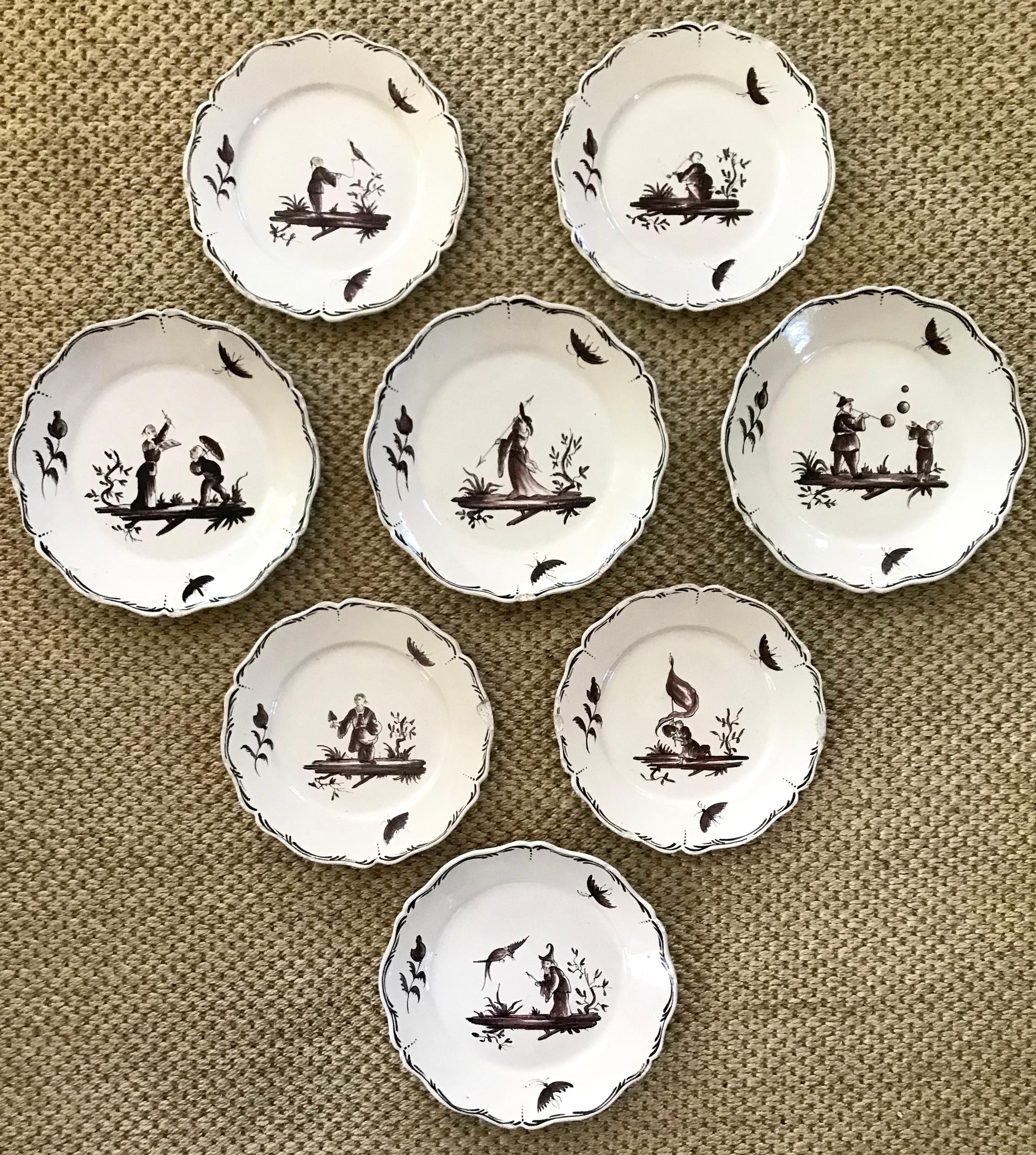 Set of eight French chinoiserie faience plates. Set of eight possibly Strasbourg plates consisting of four dinner and four luncheon plates with charming vignettes of aubergine/dark eggplant sepia hand-painted oriental figures in landscapes