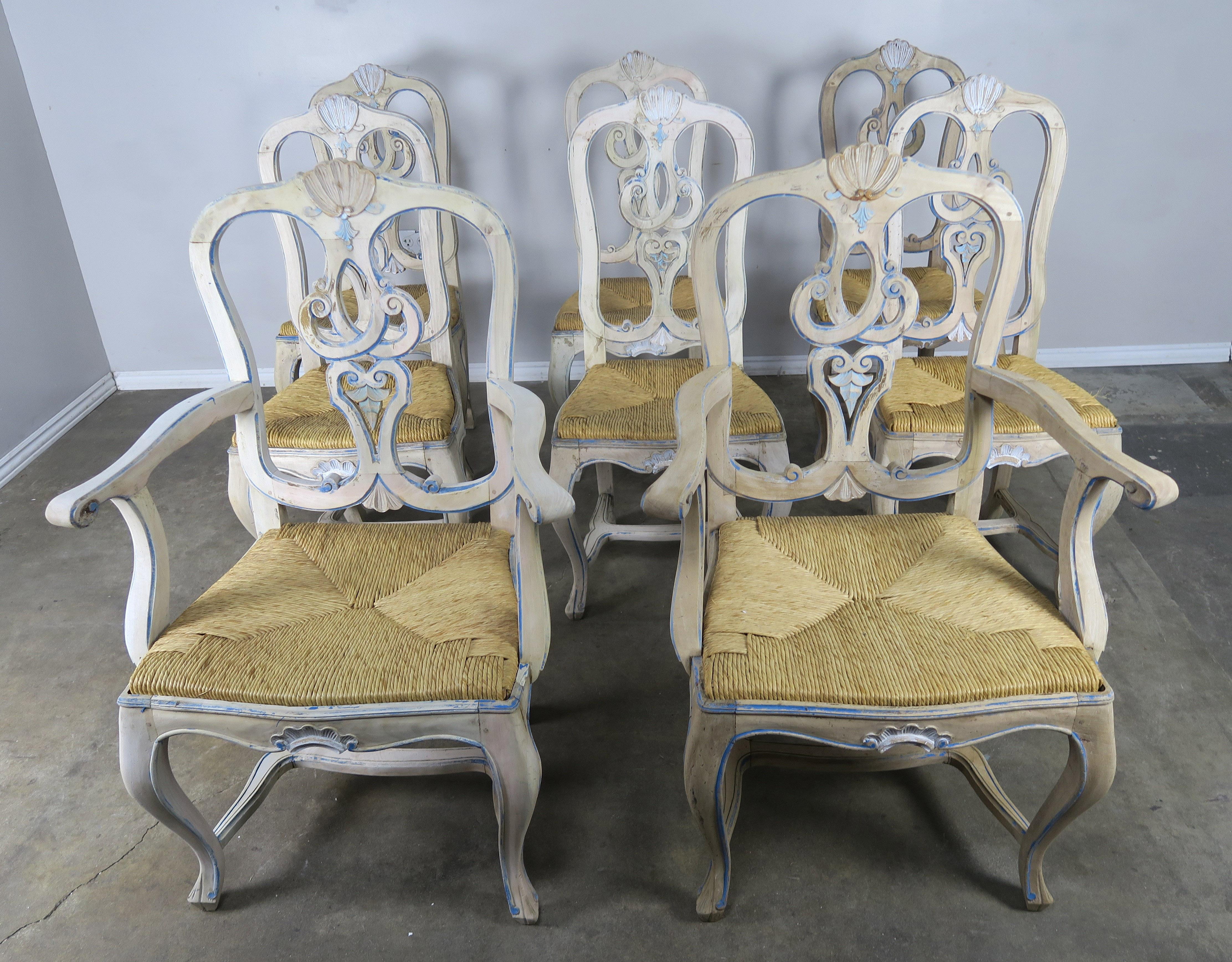 Set of (8) French country painted dining chairs with rush seats. Beautiful worn, distressed finish with missing paint throughout. Every chair has it's own unique finish and have all distressed a bit differently. Wood is exposed