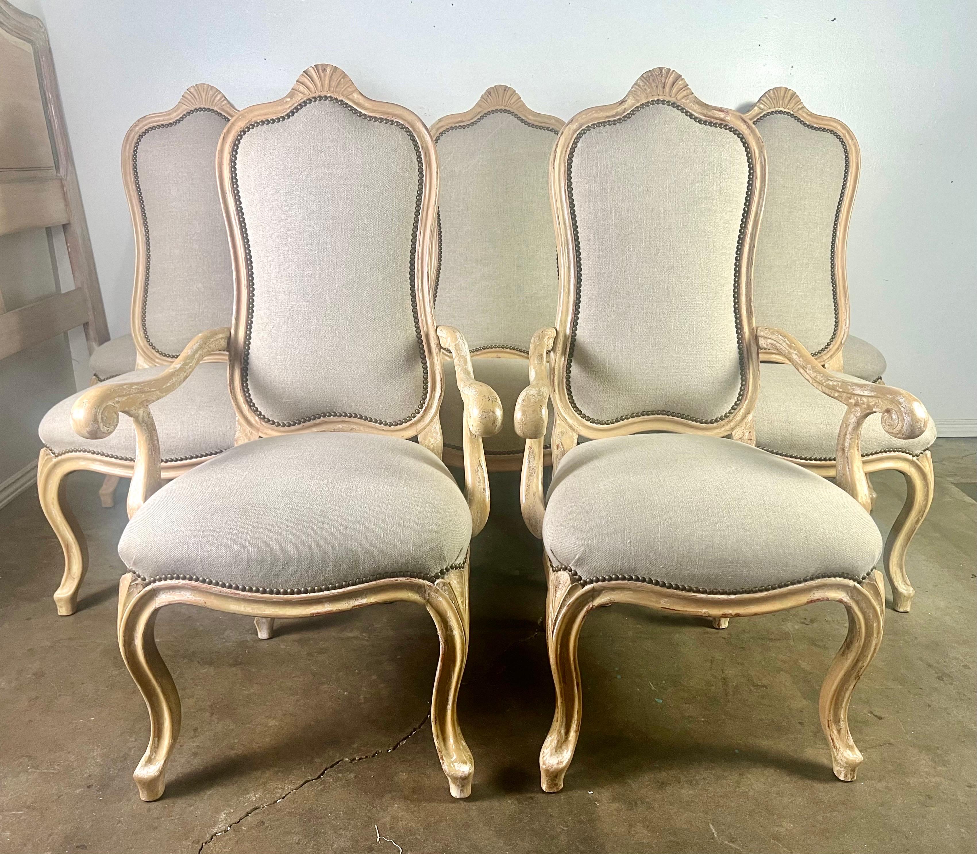 Set of eight French Louis XV style dining chairs with Belgian linen upholstery.  The bleaching process gives them a fabulous and contemporary appeal while still showcasing their classic elegance.