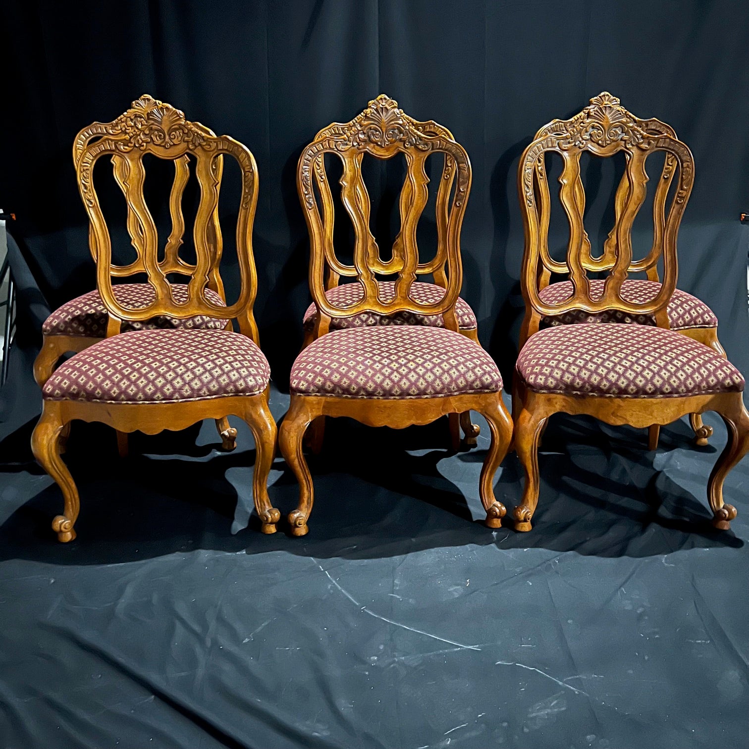 Set of eight French Louis XV style dining chairs having four cabriole legs with snail feet and lovely carved acanthus leaves and carved flowers on the top or crest of the chair frame. These are lovely Martel arm and sides chairs from Century