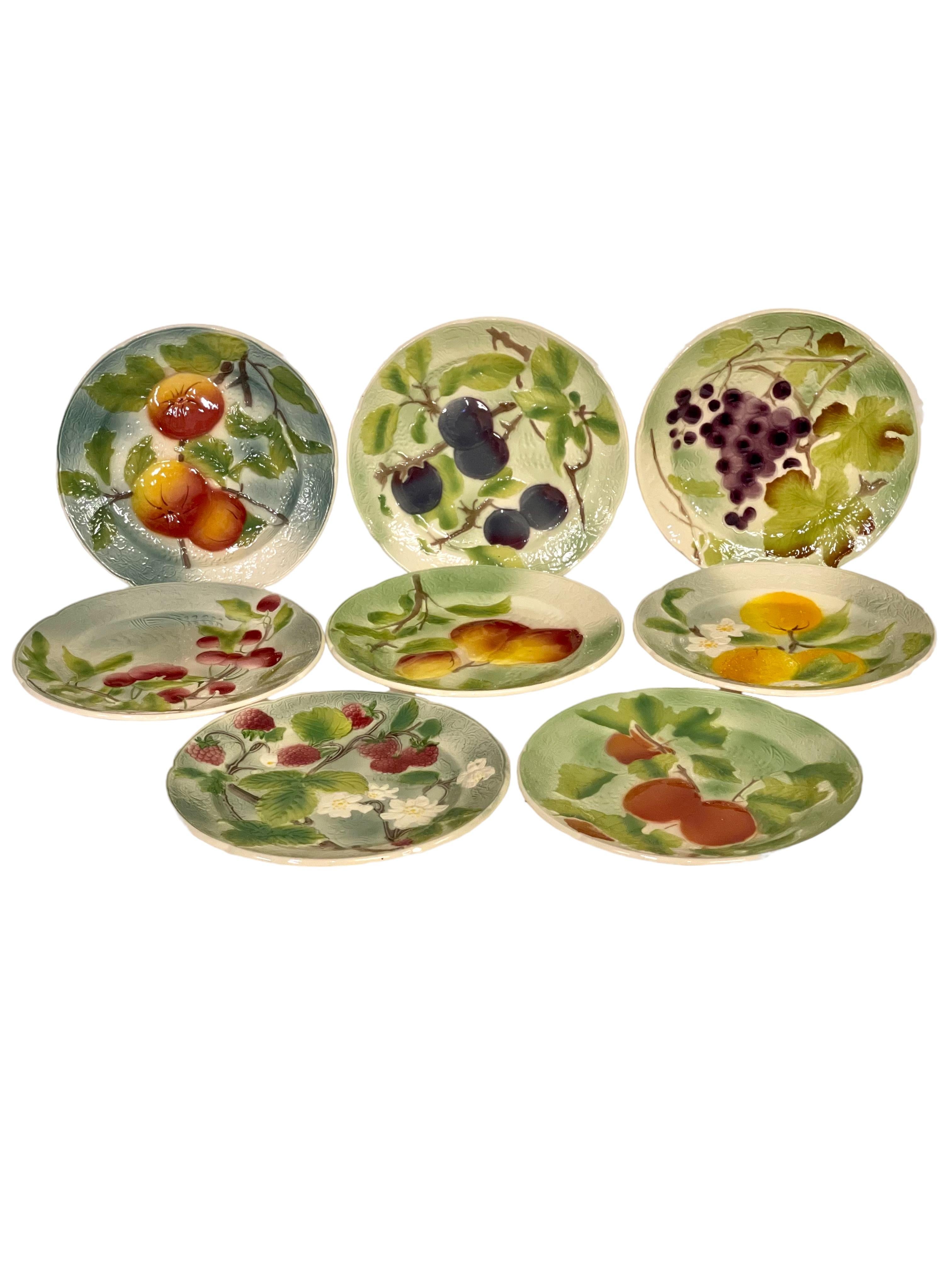 A highly collectible set of eight Majolica fruit plates by the renowned French earthenware manufacturer Saint-Clément, founded by Jacques Chambrette in 1758 and a favoured supplier for Marie-Antoinette. Majolica is made by shaping and firing a piece