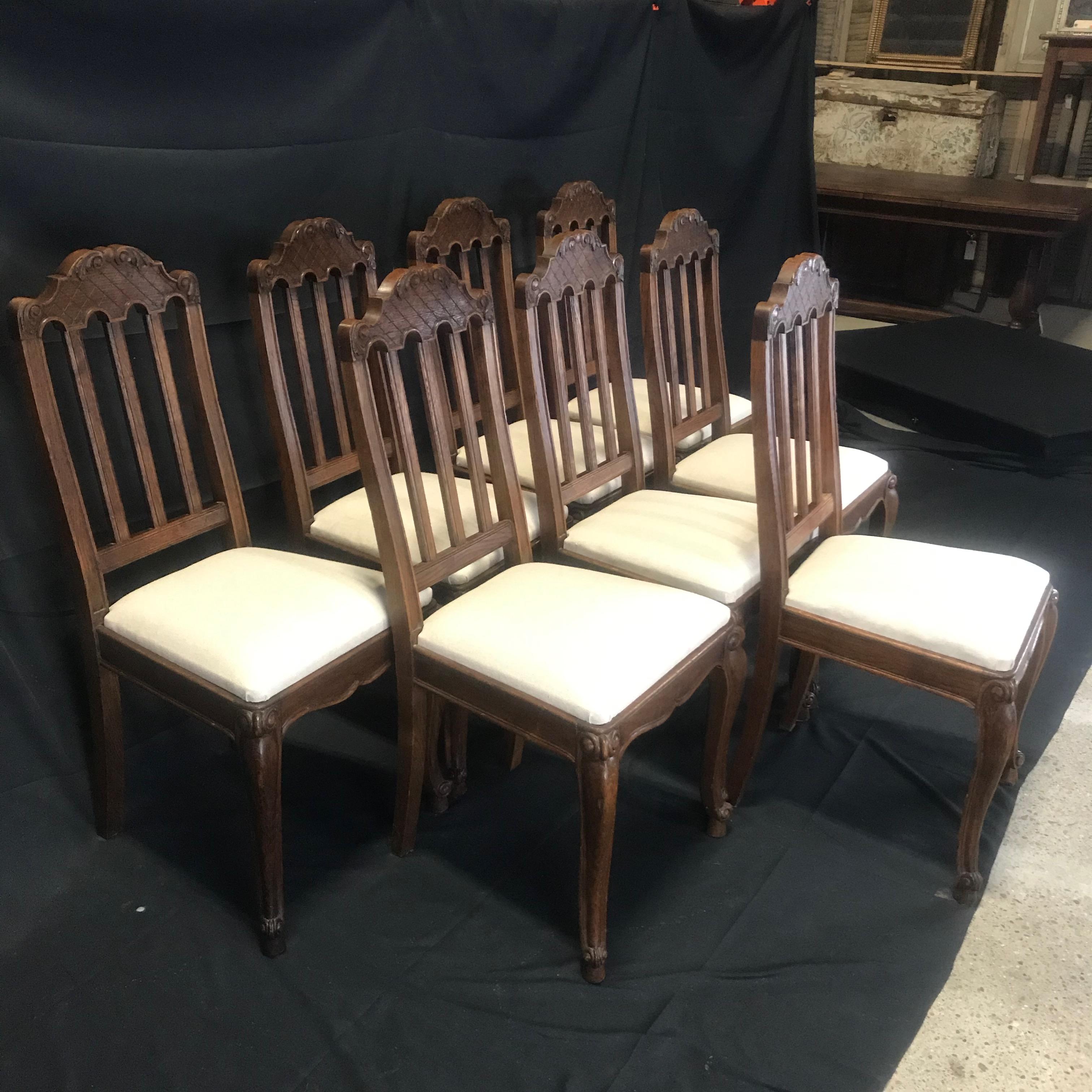 Really beautiful set of eight French oak intricately carved Louis XV chairs having snails carved into feet and top of legs. Top of backs are decorated with acanthus leaves and a diamond basketweave background. New upholstery in quality British pale