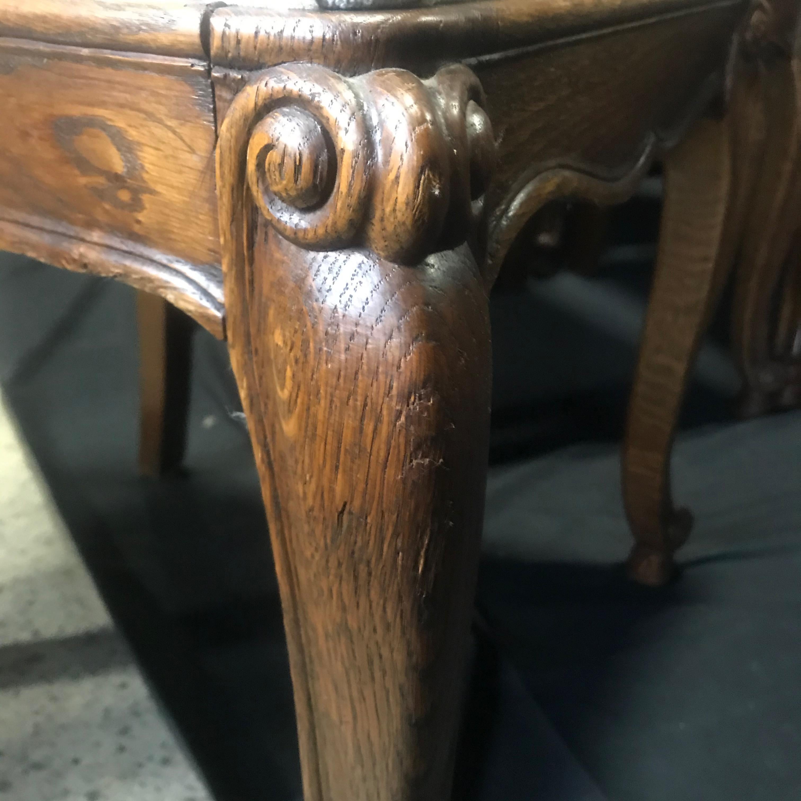 Set of Eight French Oak Intricately Carved Louis XV Chairs with Snail Feet 2