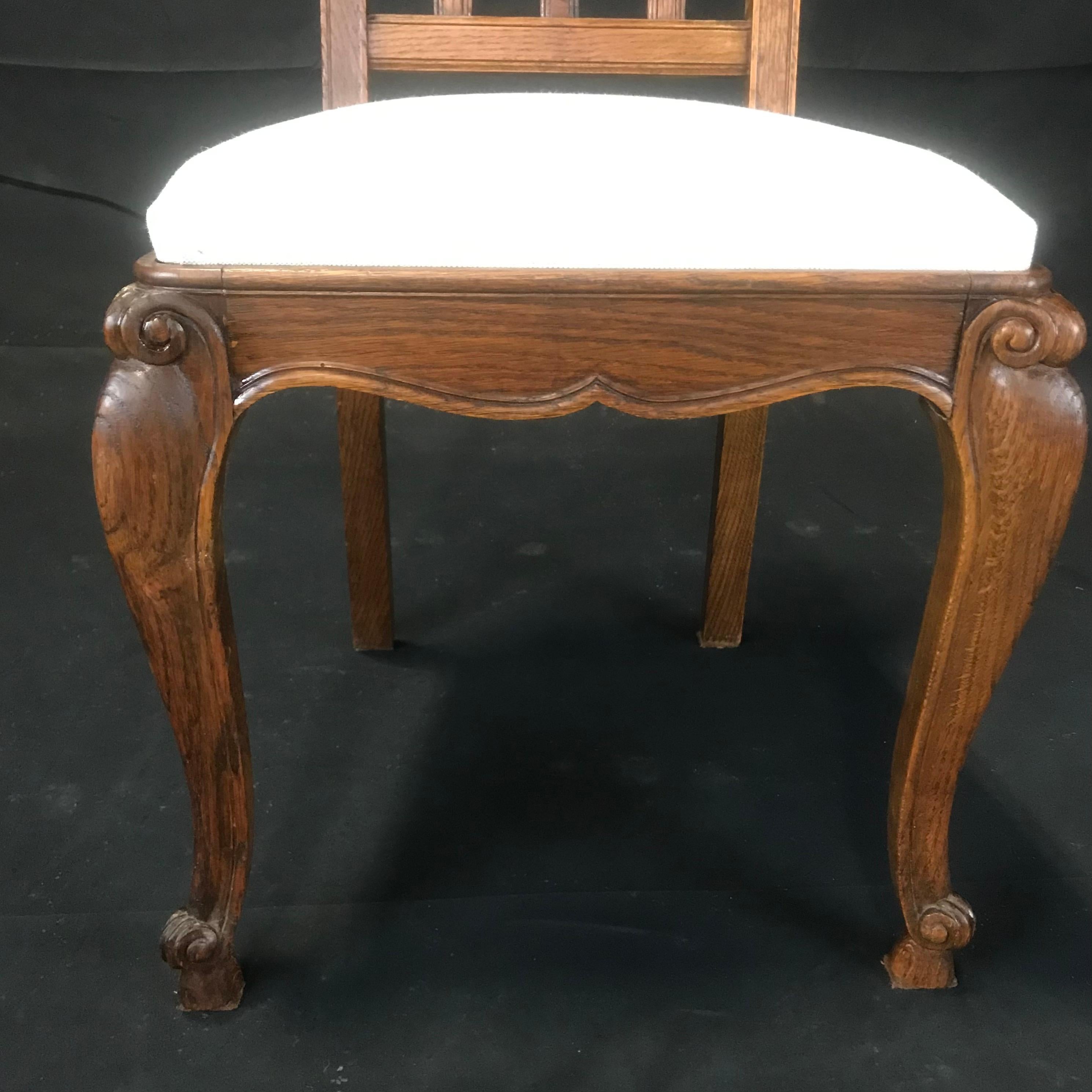 Set of Eight French Oak Intricately Carved Louis XV Chairs with Snail Feet 3