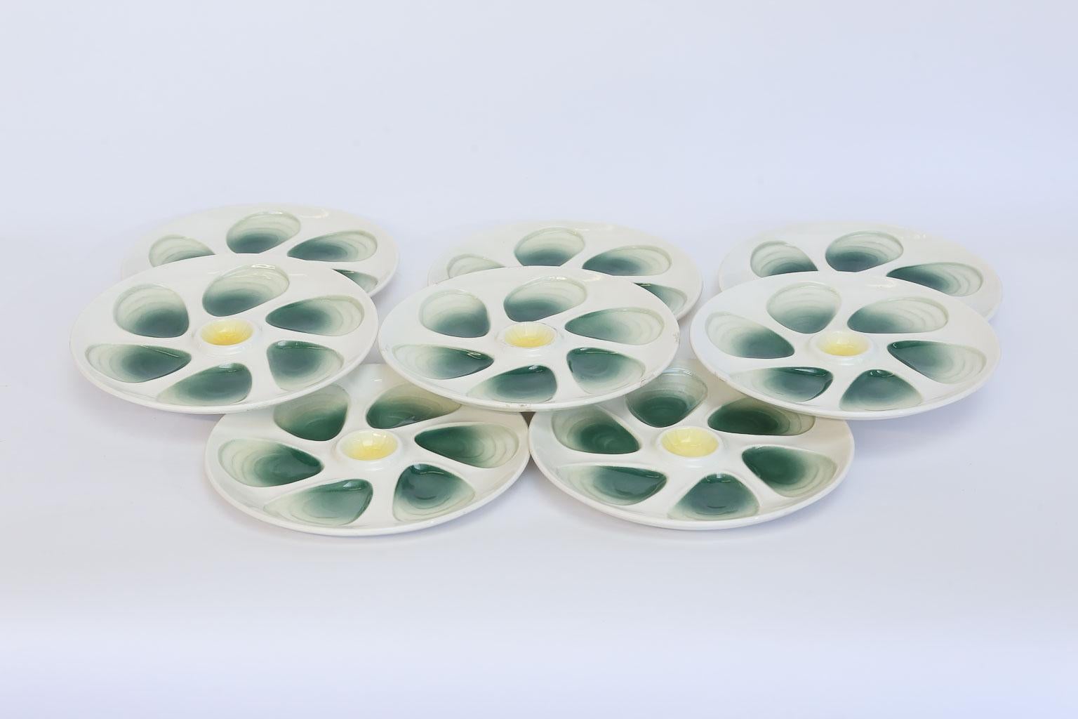 This is a set of eight French oyster plates made by and marked Salins France. The Salins faience factory was established in 1857 in Salins-les-Bains, France, and in 1968 was integrated with the faience factory of Sarreguemines. Each plate consists