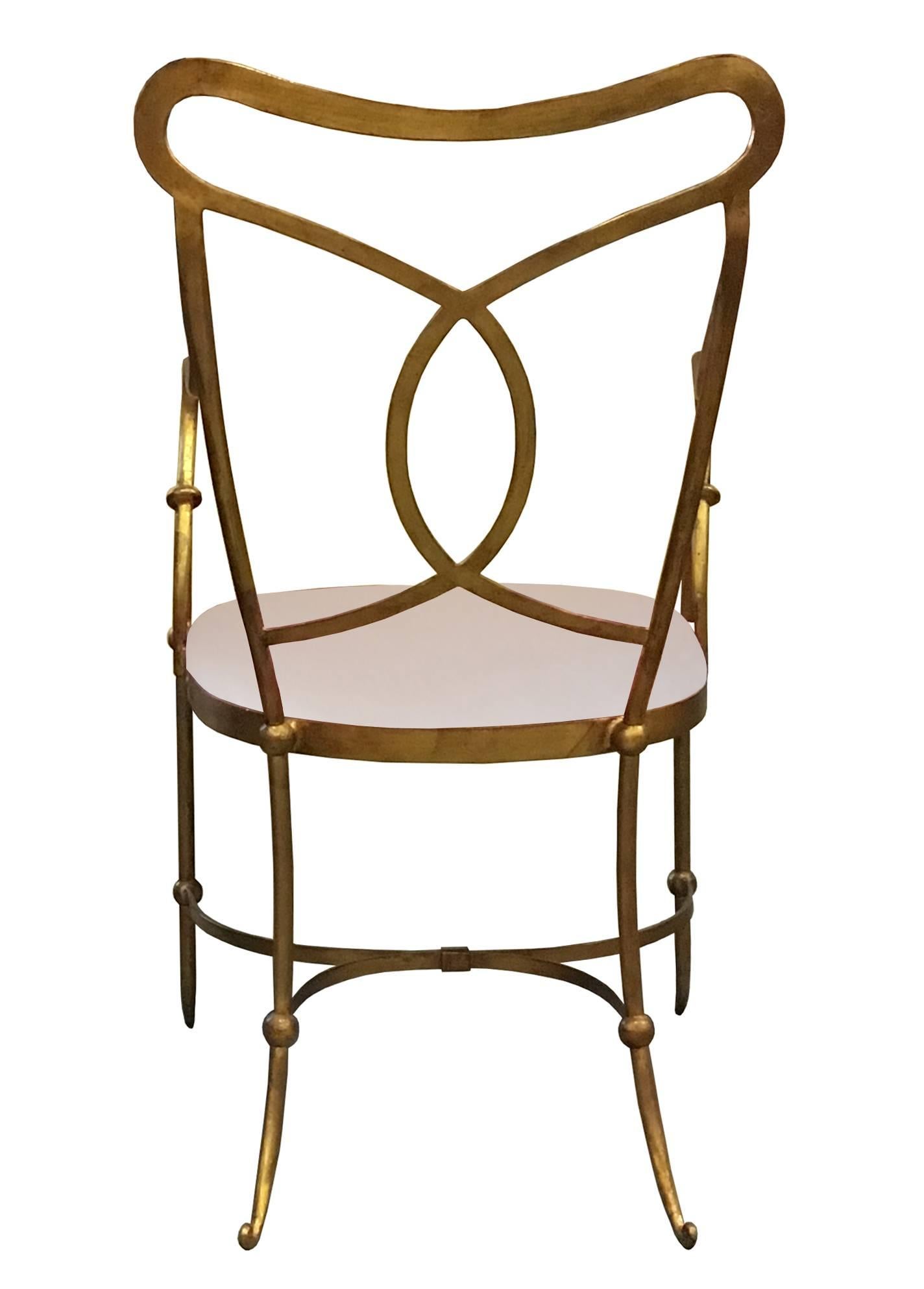 A set of decorative solid hand forged wrought iron dining chairs with gilt finish, French, 1960s.