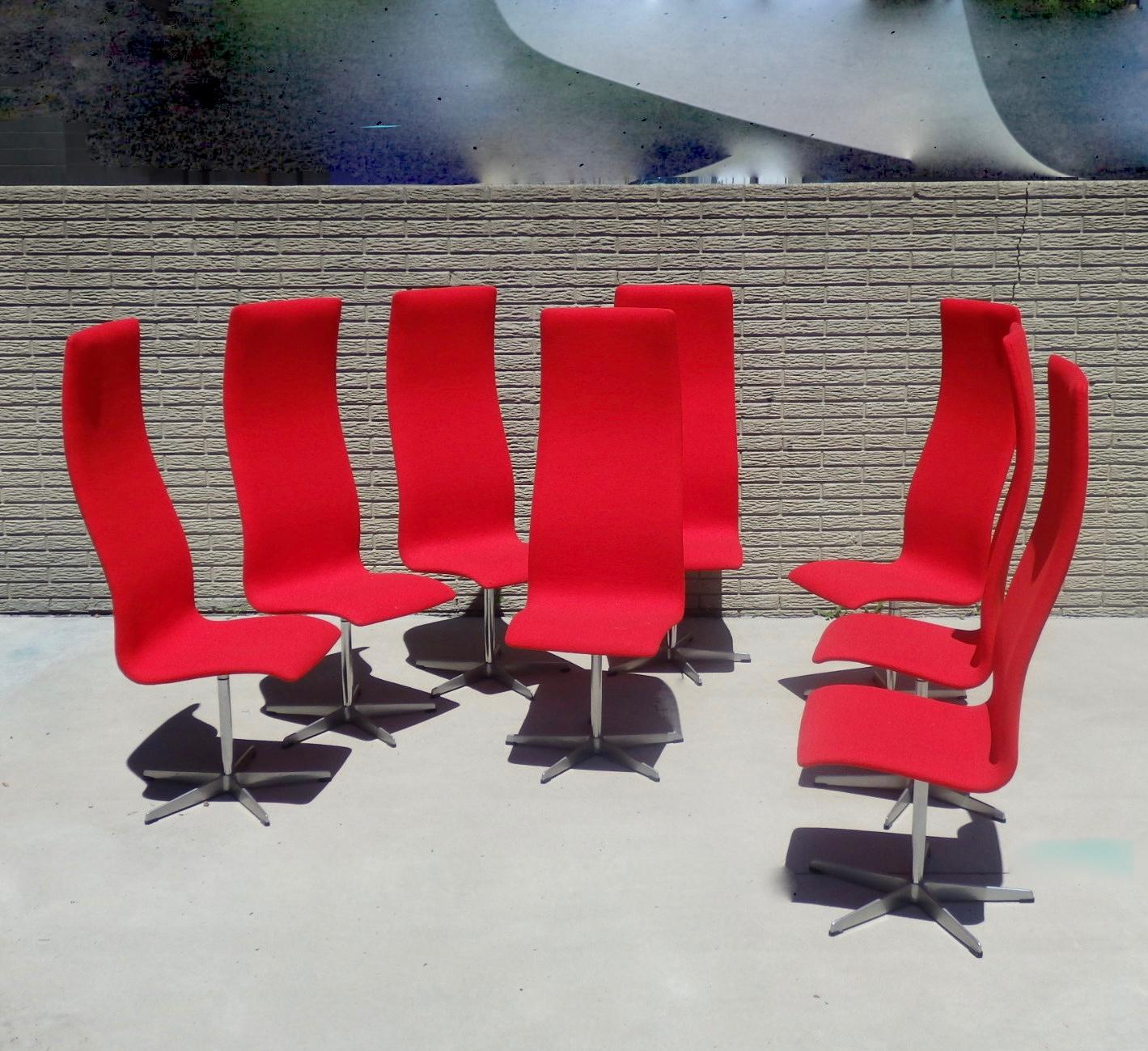 Eight Arne Jacobsen for Fritz Hansen tall back Oxford chairs. Recently covered in Maharam Kvadrat red wool textile.