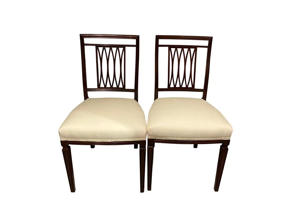 Consisting of eight side chairs, each with a rectangular back with trellis splats, upholstered seats raised on square tapered fluted legs. Resided on Park Avenue in New York for the first half of the 20th century and were graced by Cole Porter and