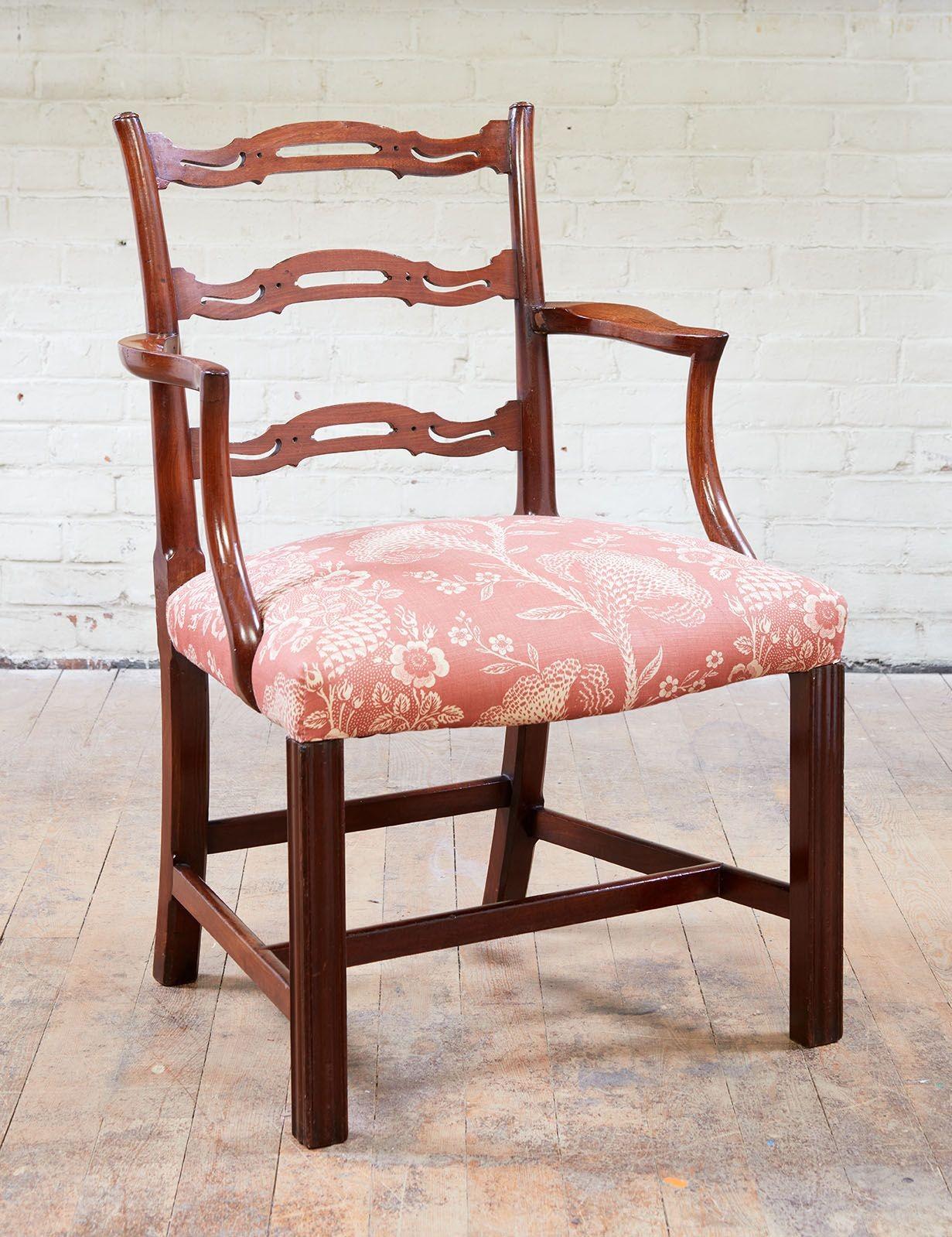 Good pair of George III period mahogany ladder back armchairs having shaped and pierced slats supported by pole shaped stiles, having shaped arms and supports with over upholstered seats and standing on molded Marlborough front legs and raked rear