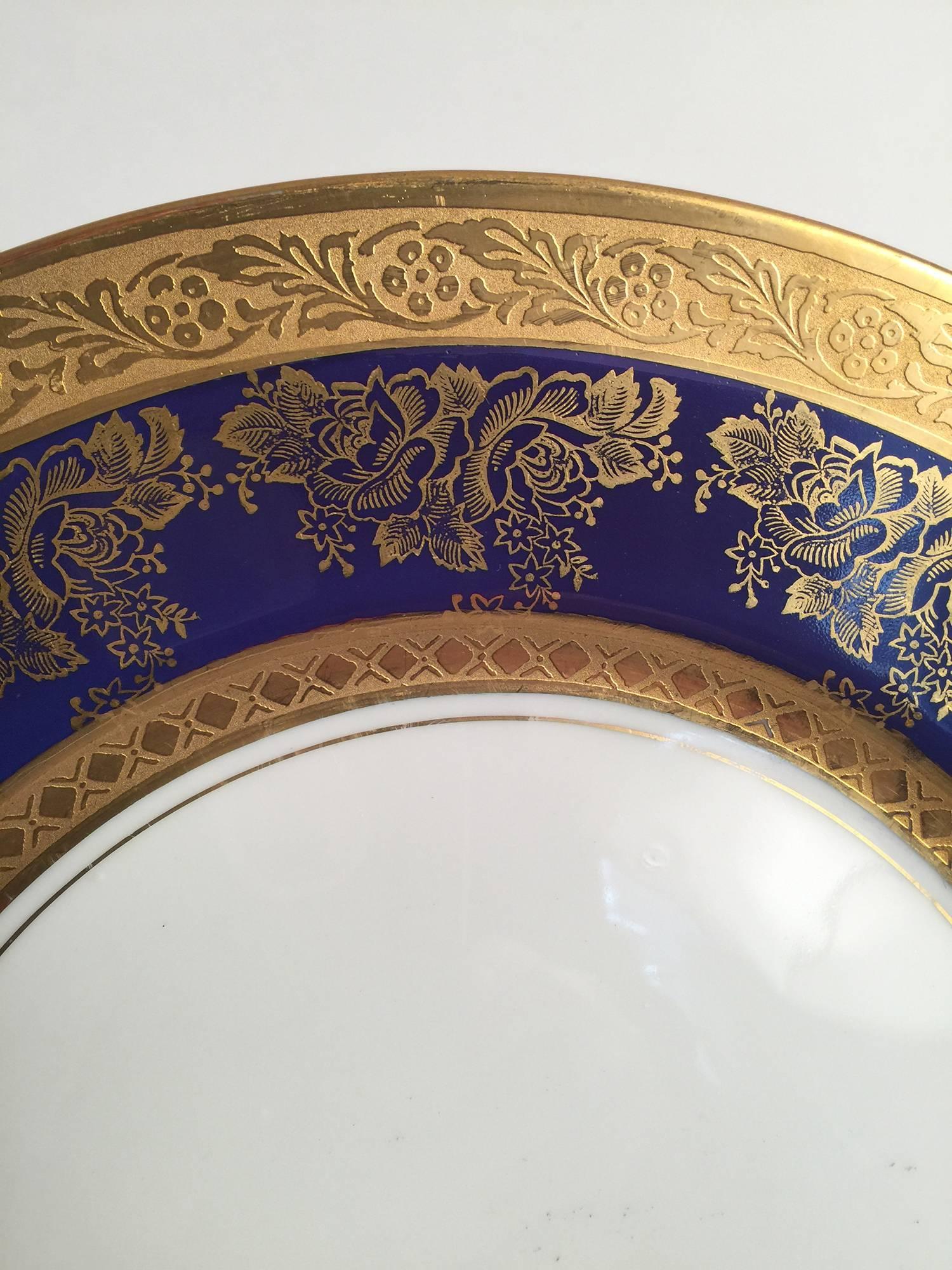 Set of eight gold and cobalt blue service plates marked czech. The rich cobalt background with gilt overlay decotation with white porcelain background. $950 gq dimensions: 11” diameter.
