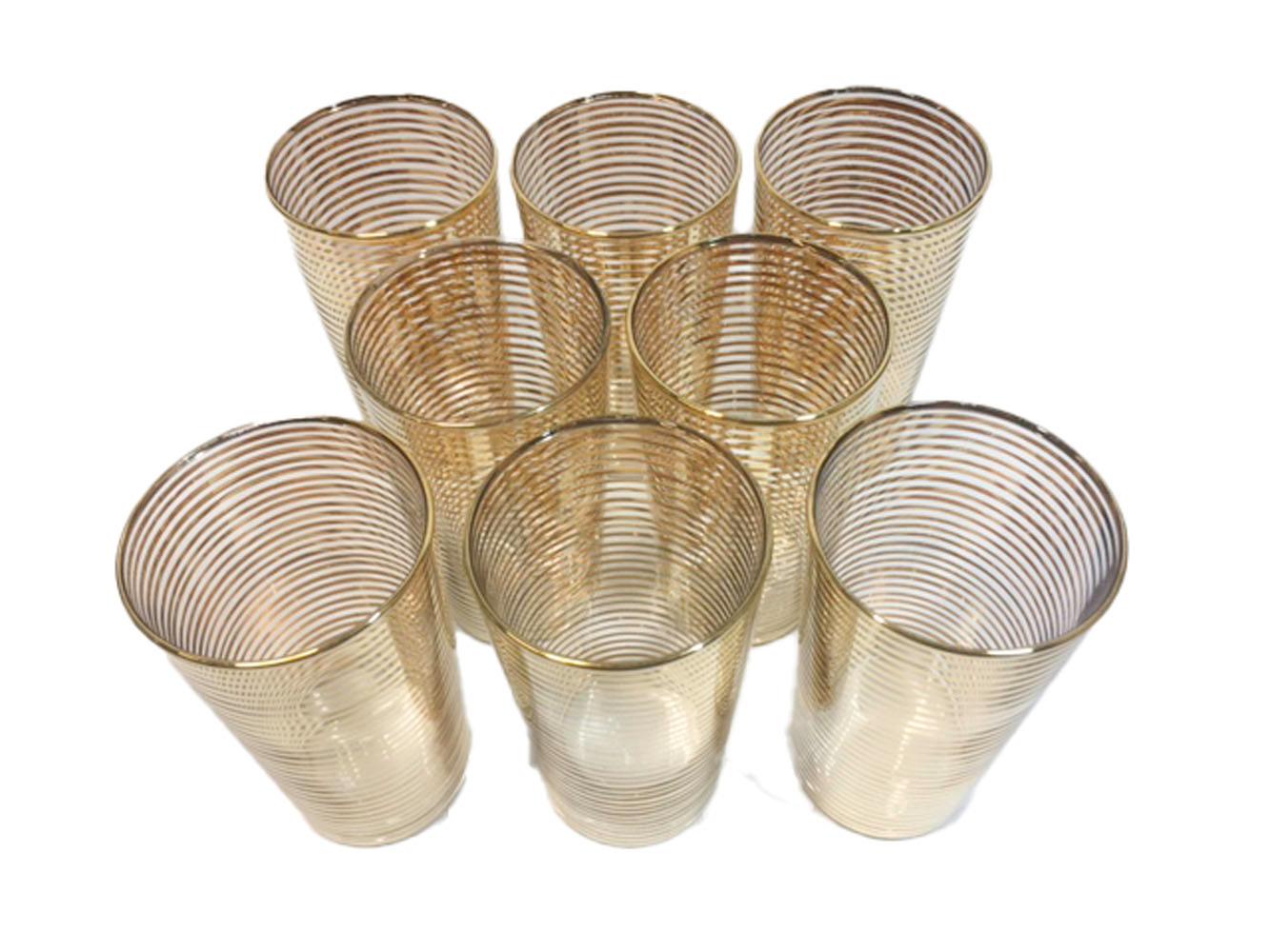 Set of eight highball glasses with alternating gold bands.