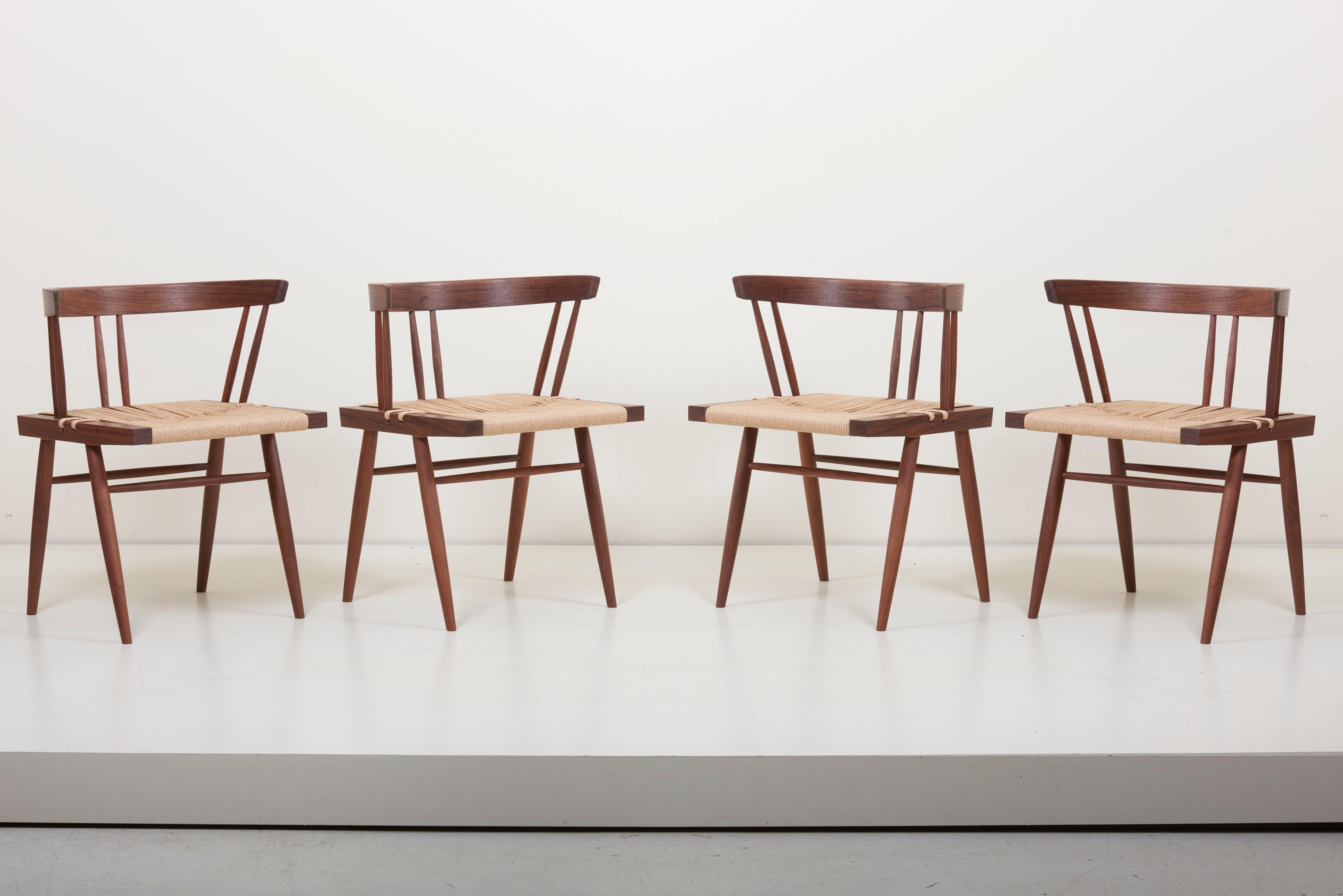 Set of 6 Grass-seated chairs, designed by George Nakashima and manufactured by George Nakashima Studio in the US. The square seat typically found in walnut and woven sea-grass. Outstanding quality.
