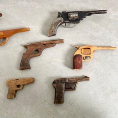 Set of Eight Hand-Carved Wooden Toy Guns, Folk Art, USA, 1950s