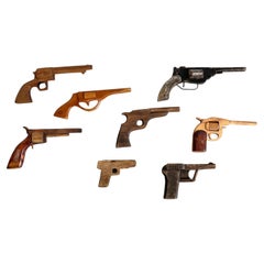 Set of Eight Hand-Carved Wooden Toy Guns, Folk Art, USA, 1950s