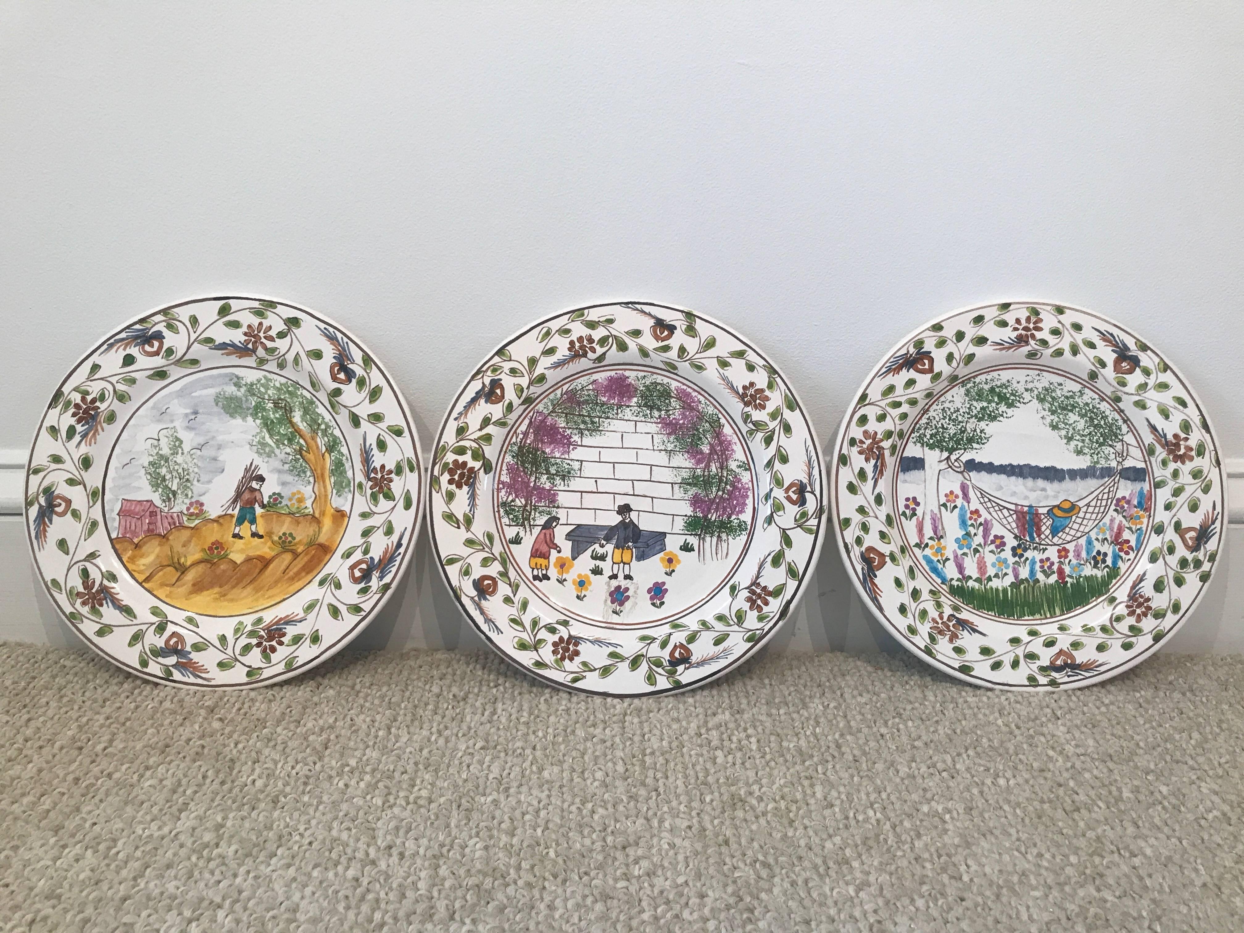 Charming scenes of rural family life have been hand-painted on this set of eight plates that were custom-made in Portugal. The colors are rich and the contrast is great; would make an ideal display on a wall or a tabletop.