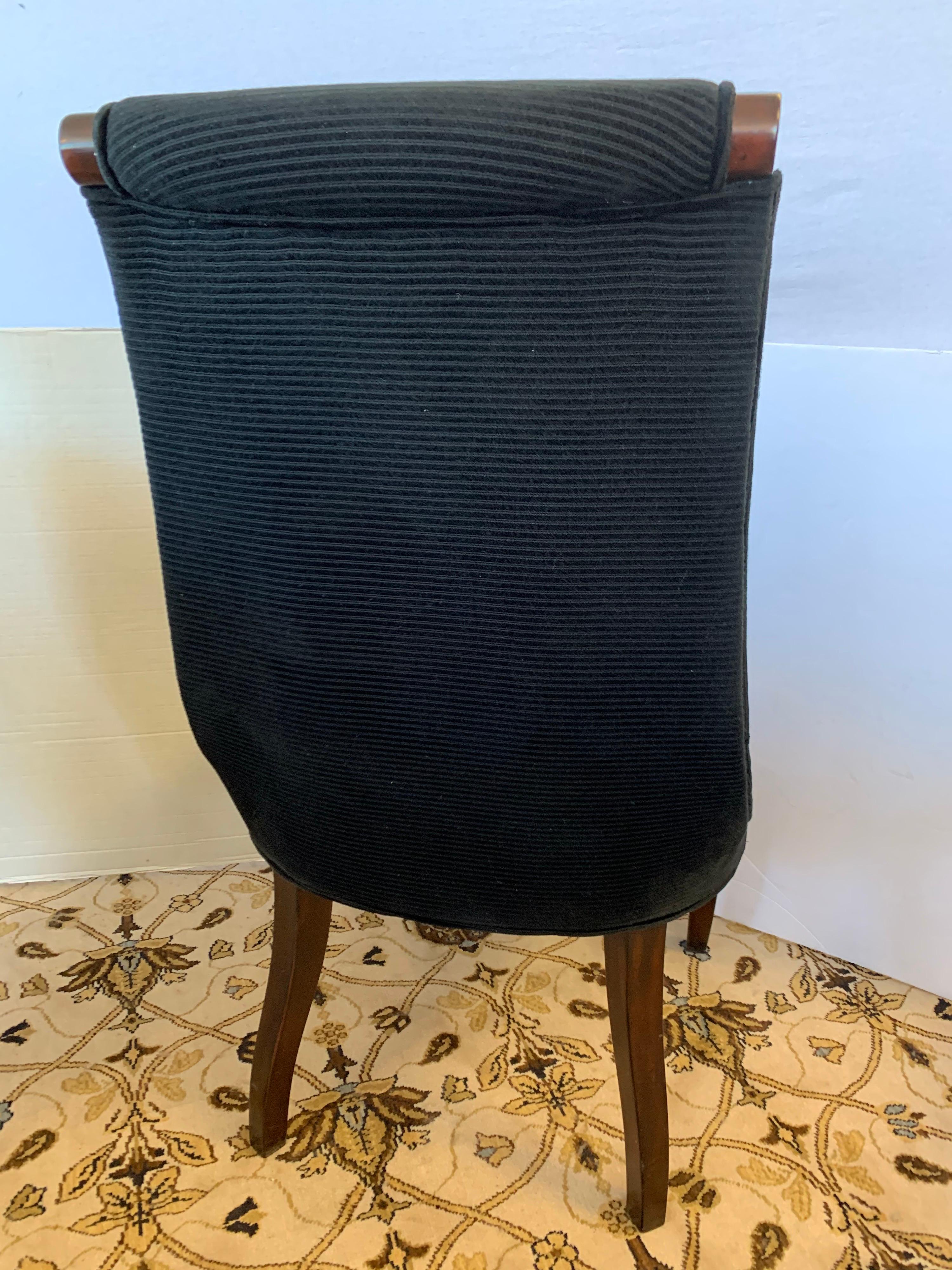 Magnificent set of eight Henredon dining chairs done in mahogany wood and a luxurious
black velvet fabric that has subtle pinstripes running horizontally. All vendor hallmarks are at bottom
and these chairs originally retailed at 1895.00 per