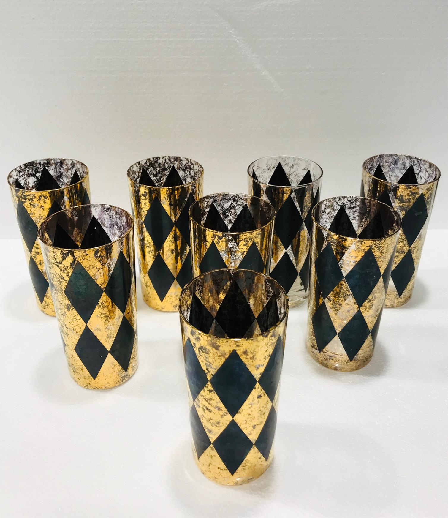 Set of eight Mid-Century Modern highball glasses with Harlequin design. Tall cocktail glasses featuring hand blown design with 22-karat gold leaf flecks and black diamond pattern throughout. Hollywood Regency set makes a chic addition to your