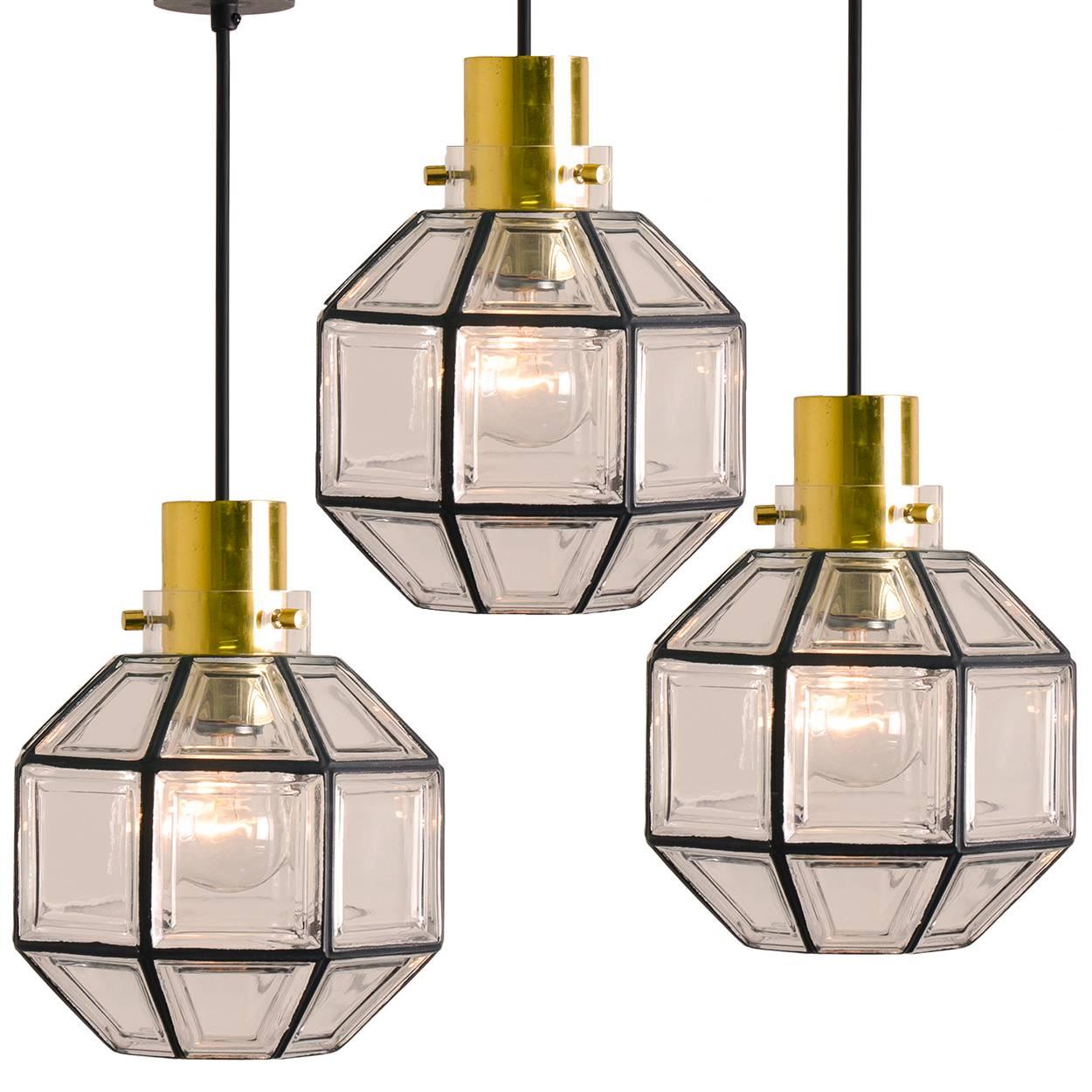 This beautiful set octagonal glass light fixtures were manufactured by Glashütte Limburg in Germany during the 1960s. Beautiful craftsmanship. Each lamp, made from elaborate clear glass, features one E27 socket and brass suspension.

Size of the