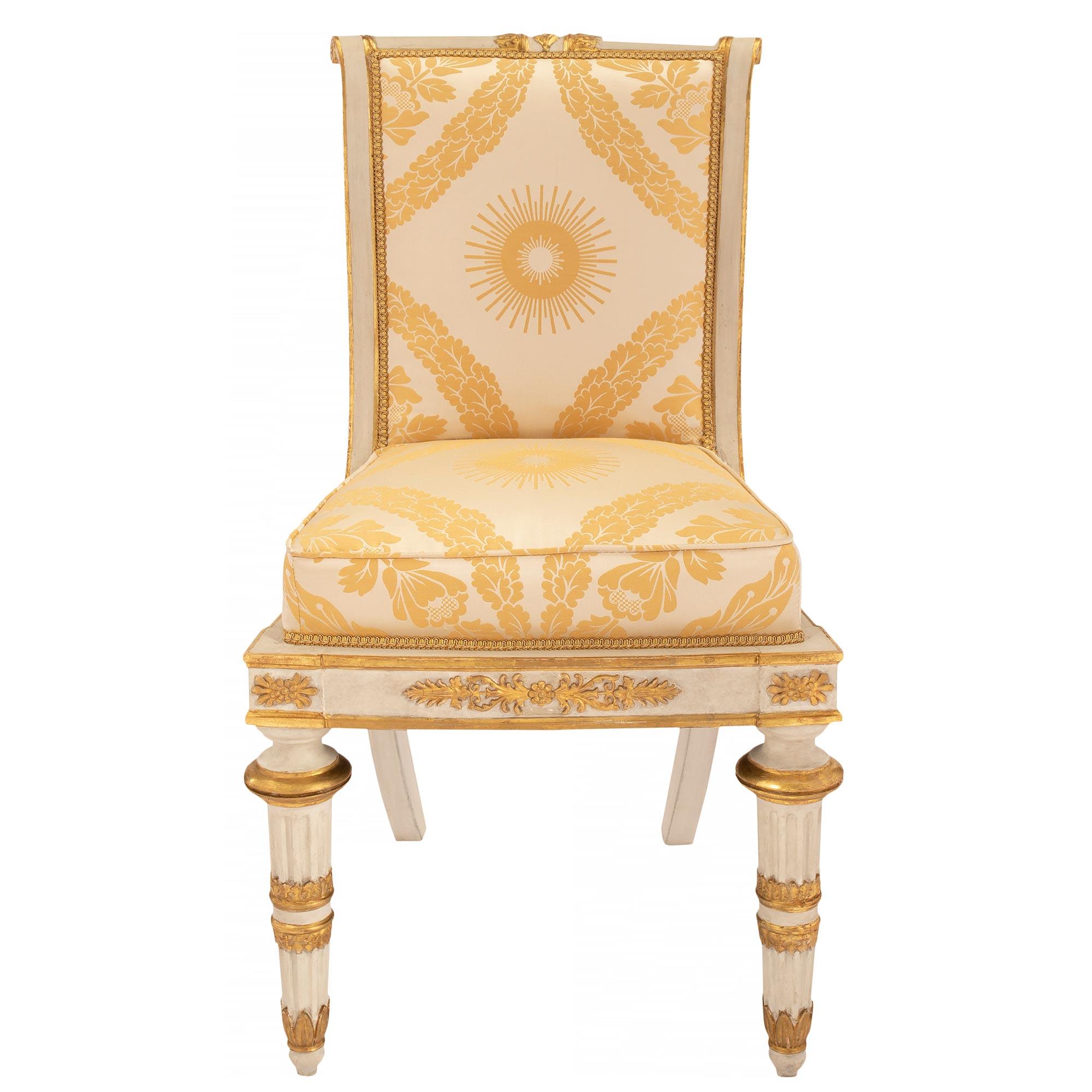 Ein auffälliger und vollständiger Satz von acht italienischen Esszimmerstühlen aus der Toskana im neoklassizistischen Stil des frühen 19. Jeder Stuhl steht auf patinierten, kannelierten Beinen mit feinen, topieförmigen Füßen und hübschen,