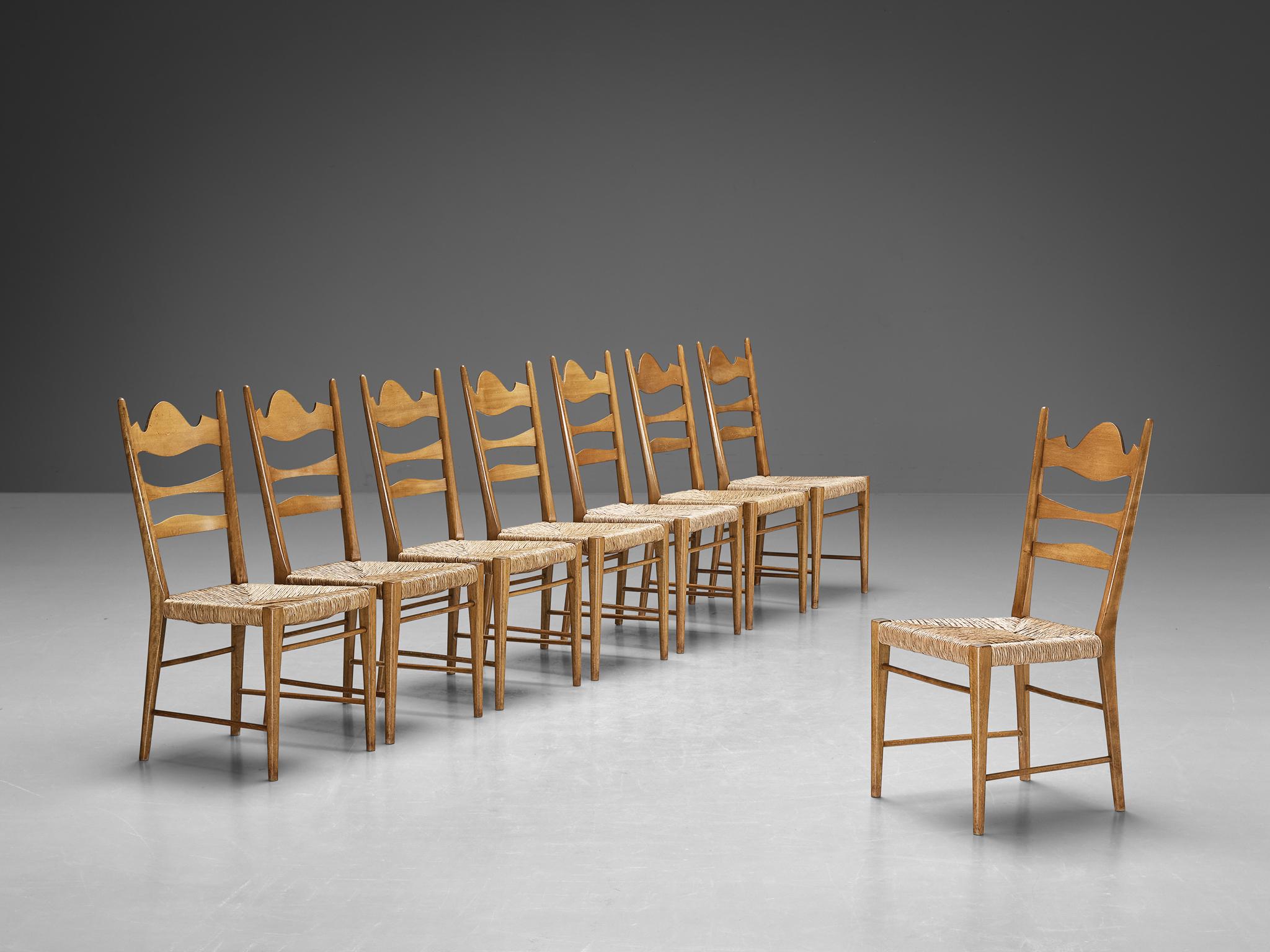 Set of eight dining chairs, beech, straw, Italy, 1950s

Crafted with a refined decorative allure and a rustic inclination, these chairs present exquisite craftsmanship and intricate woodcarvings, showcasing a unique design. The backrest features