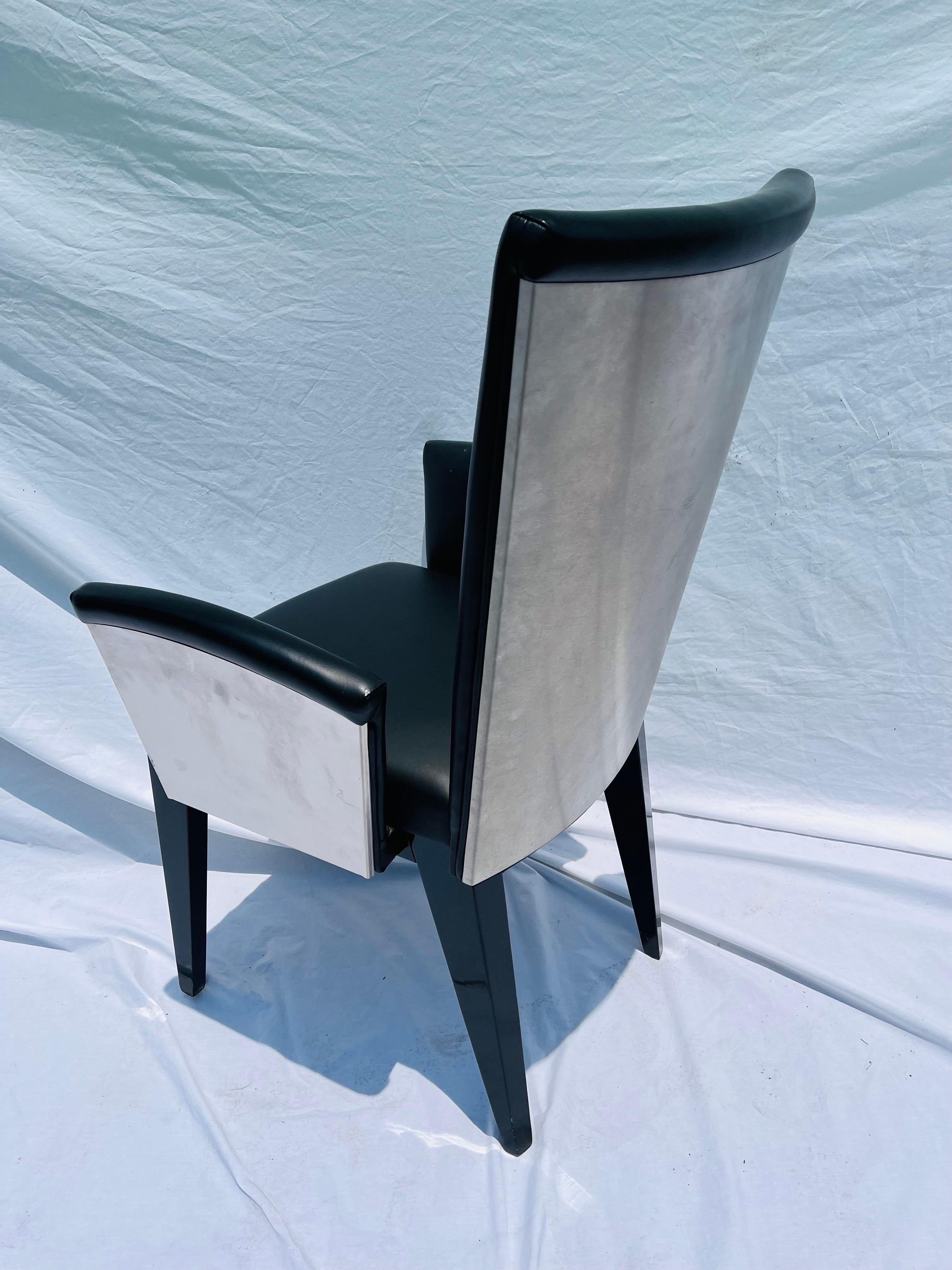 A set of eight, post modern style, leather, stainless steel and wood Italian dining arm chairs. With clean lines clearly inspired by classic designers Renzo Fauciglietti and Graziella Bianchi when they designed the Bottega chair for Design Within