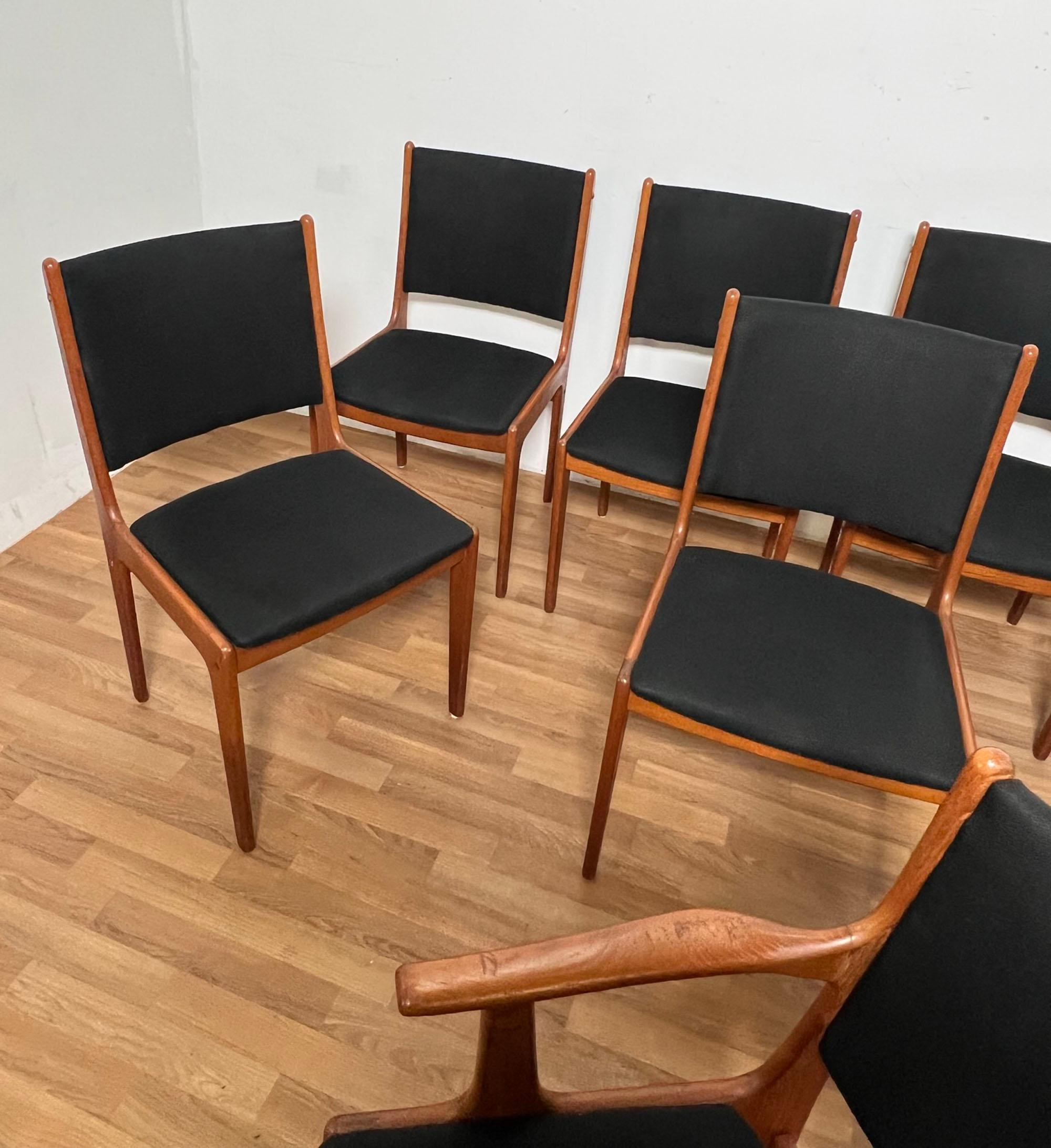 Set of eight Danish teak dining chairs by Johannes Andersen for Uldum Mobelfabrik, consisting of one arm chair and seven sides.

Side chairs measure: 19.25