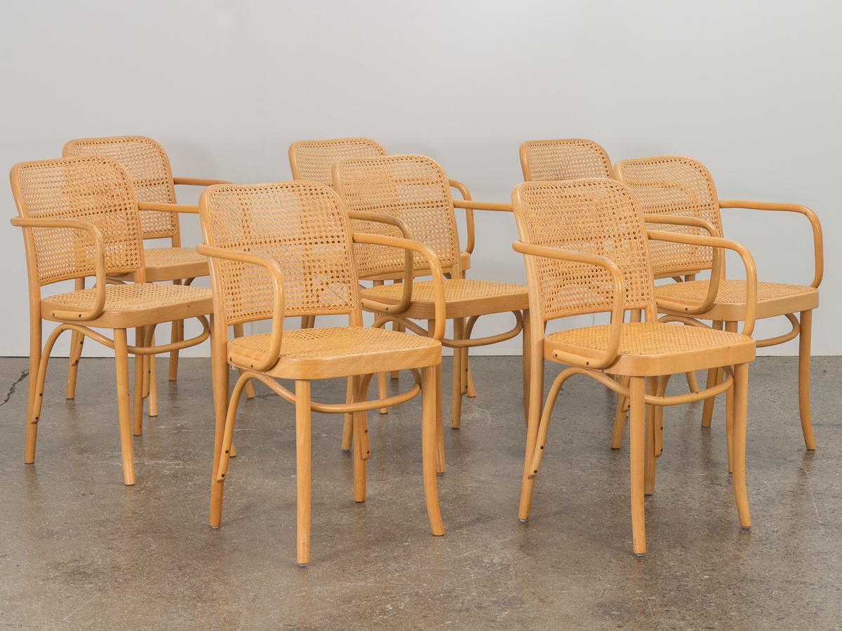 Classic set of dining armchairs designed by Joseph Hoffman for Thonet. Sculptural blonde wood frame with tightly-woven caned seat and back. Our chairs are an early vintage edition, manufactured in Poland according to their label. All chairs are in