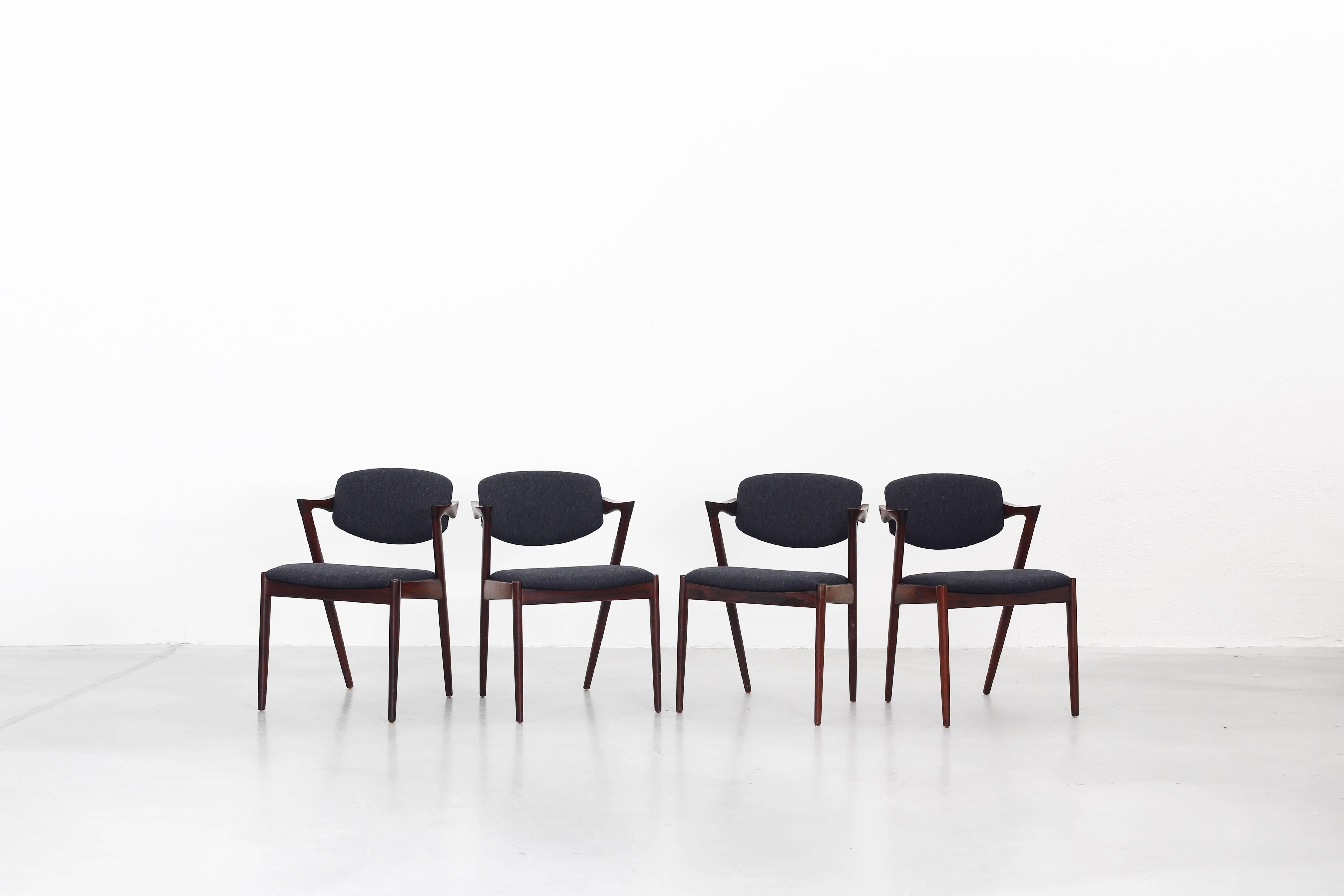 Very beautiful set of eight dining chairs designed by Kai Kristiansen and produced by V. Schou Andersen, Denmark in 1964. The chairs are in a very good condition, all of them were newly reupholstered with a high quality fabric in dark grey by