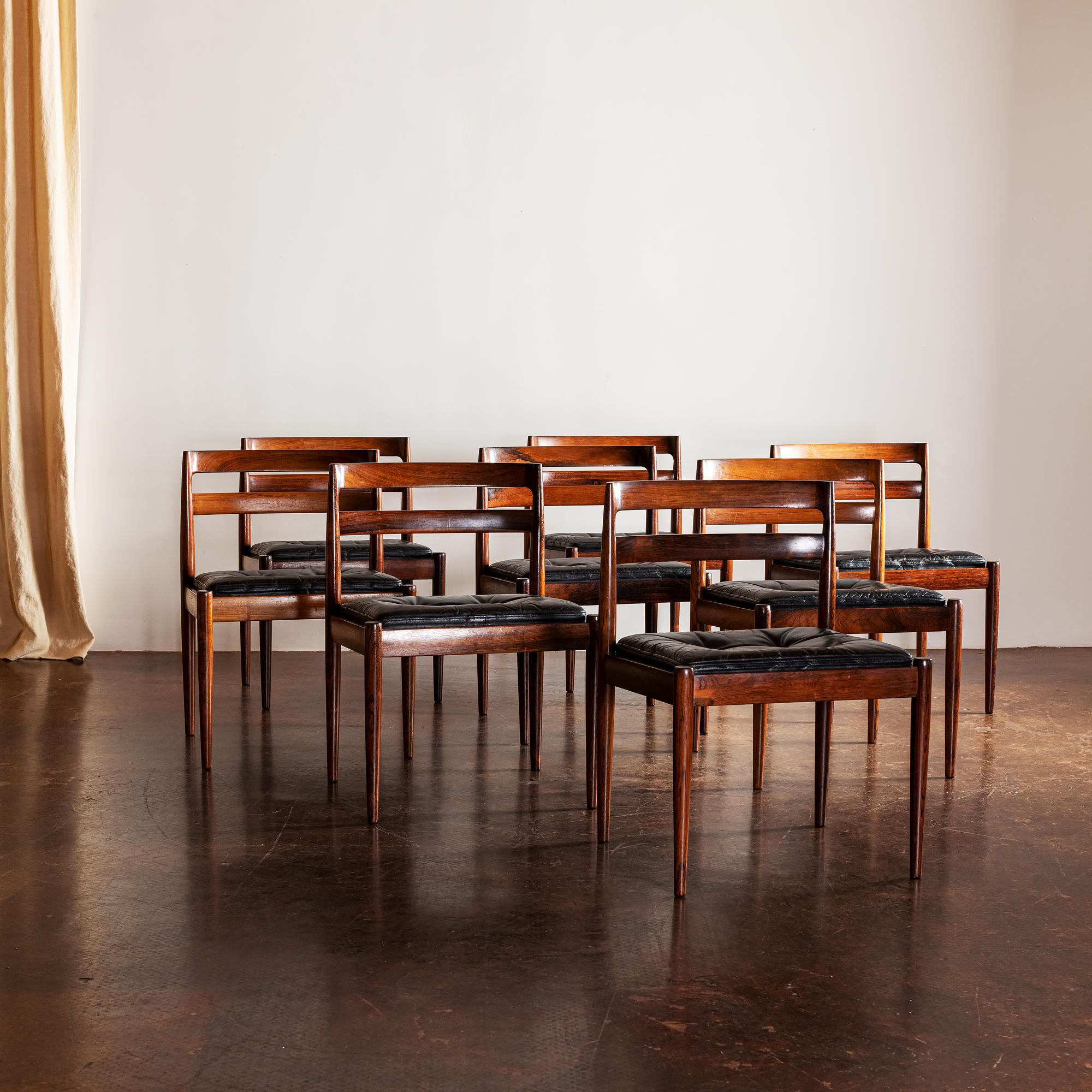 A set of eight Kai Kristiansen dining chairs in rosewood and black leather for Magnus Olesen in gorgeous condition with perfect patina on the leather seats, Denmark, 1960.