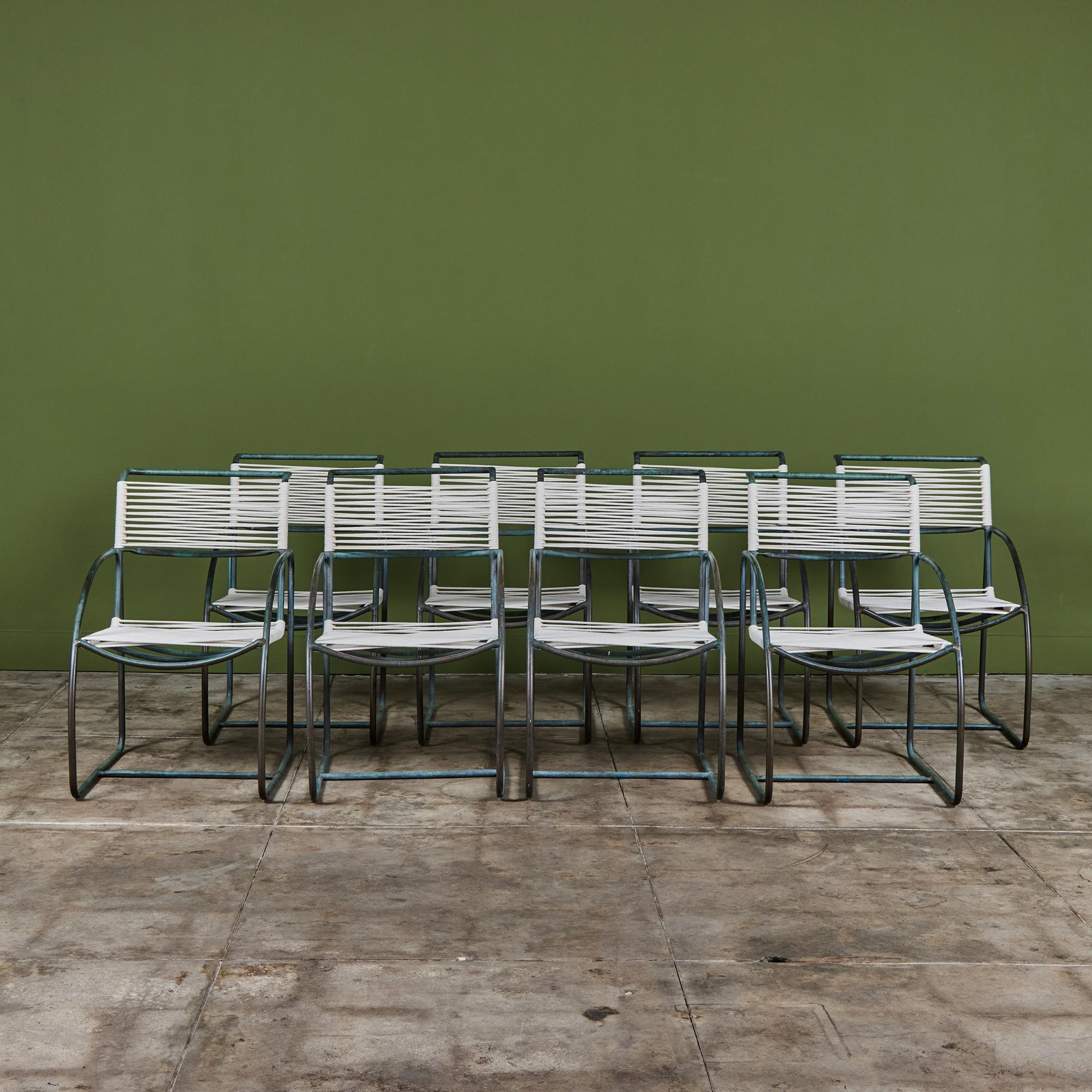 Set of eight patio dining armchairs by Kipp Stewart for Terra of California, USA c.1970s. The set features patinated bronze tube framed armchairs, with new cotton rope that has been woven to the same pattern and specifications as was originally on