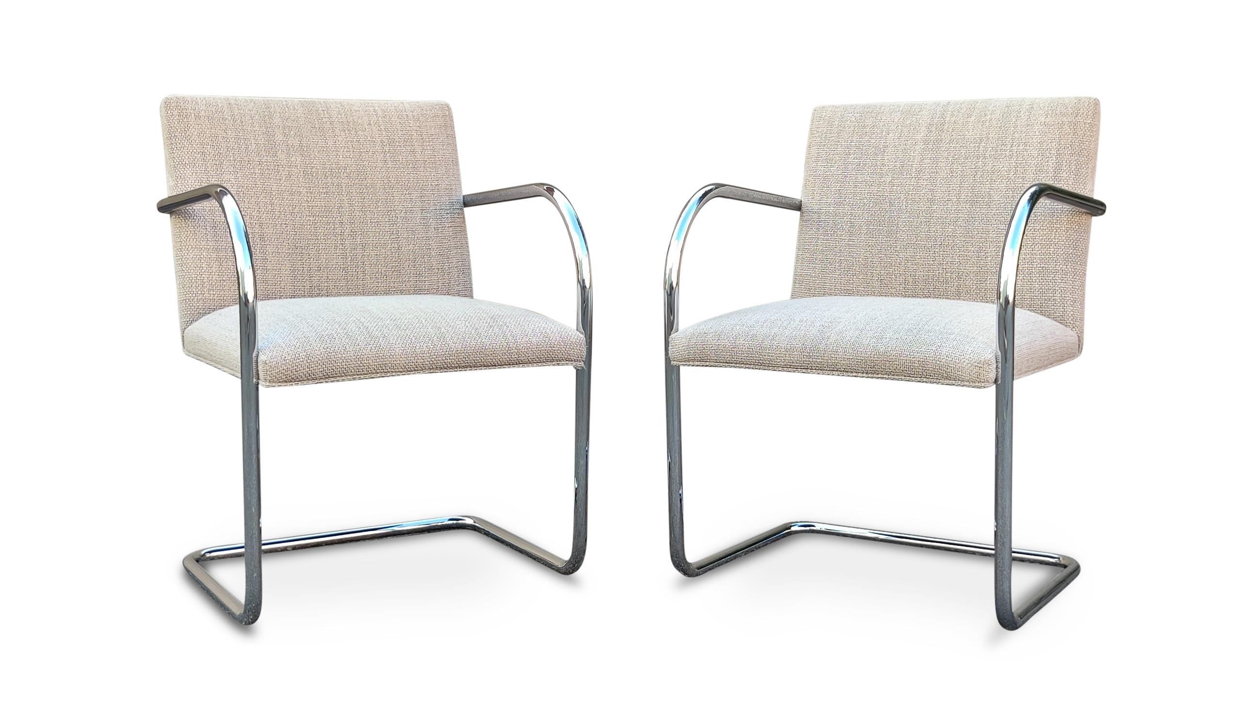 A lovely and complete set of 10 Brno armchair dining chairs designed by Ludwig Mies van der Rohe and produced by Knoll. These feature chrome tubular frames with light grey wool blend fabric. Chairs are in very good and hardly used condition. Each