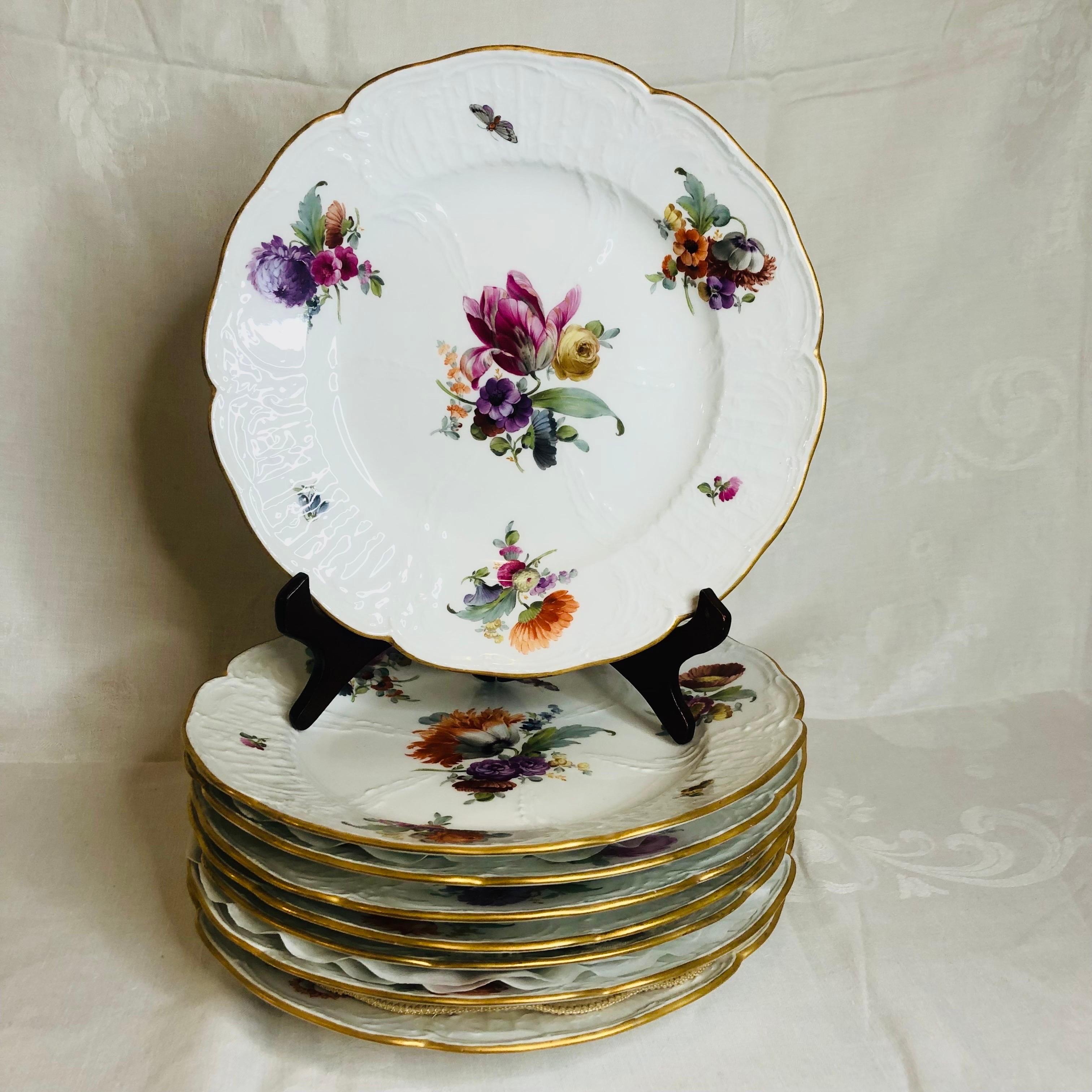 This is a gorgeous set of KPM dinner plates. Each KPM dinner plate has a different central bright colored bouquet of flowers. Each flower bouquet is masterfully painted by an extremely talented KPM artist. In addition to this beautiful central