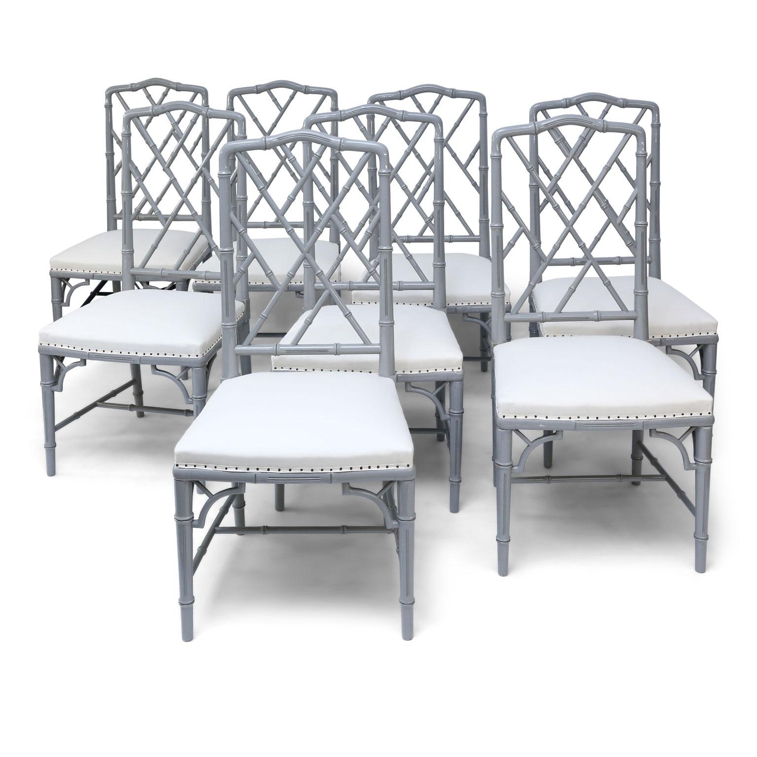 Set of eight-light gray lacquered dining chairs from France, dating to the 1970s. Faux bamboo frames carved in Chippendale style and finished in a warm gray lacquer. Upholstered in white ticking (meant to be covered in your own fabric). Finish is