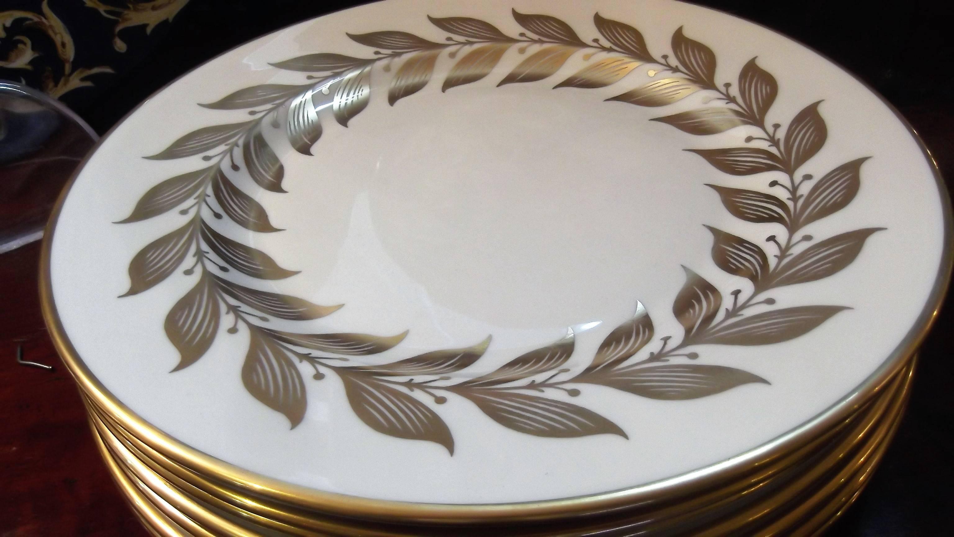Elegant set of eight service plates made in Meridian Connecticut, marked with a blue SC mark. Ivory background with gold wreath border and gold edge, circa 1950. Measures: 10.5