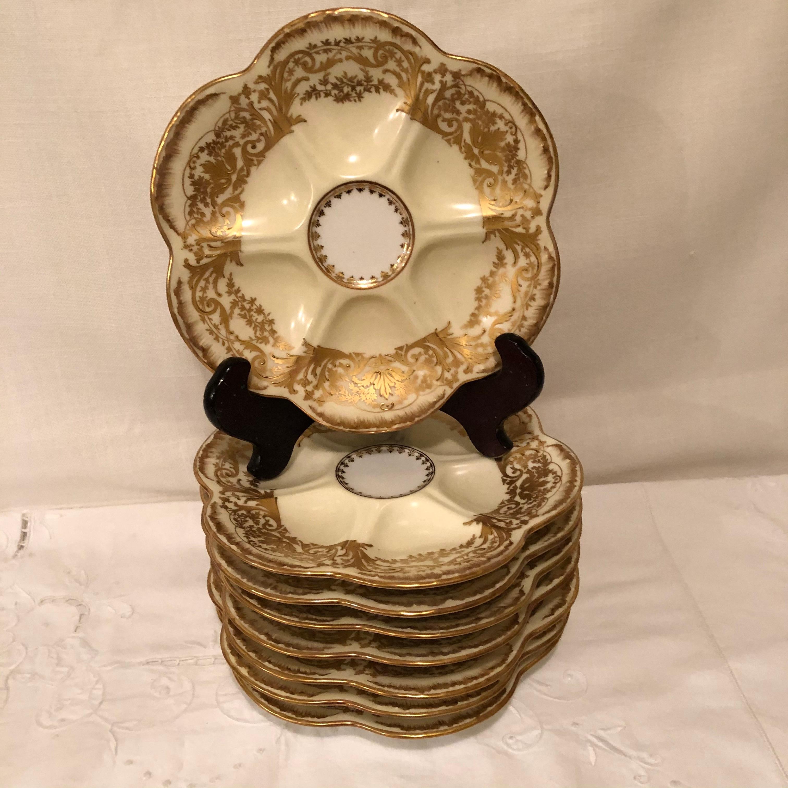 Gilt Set of Eight Limoges Oyster Plates with Profuse Raised Gold Decoration
