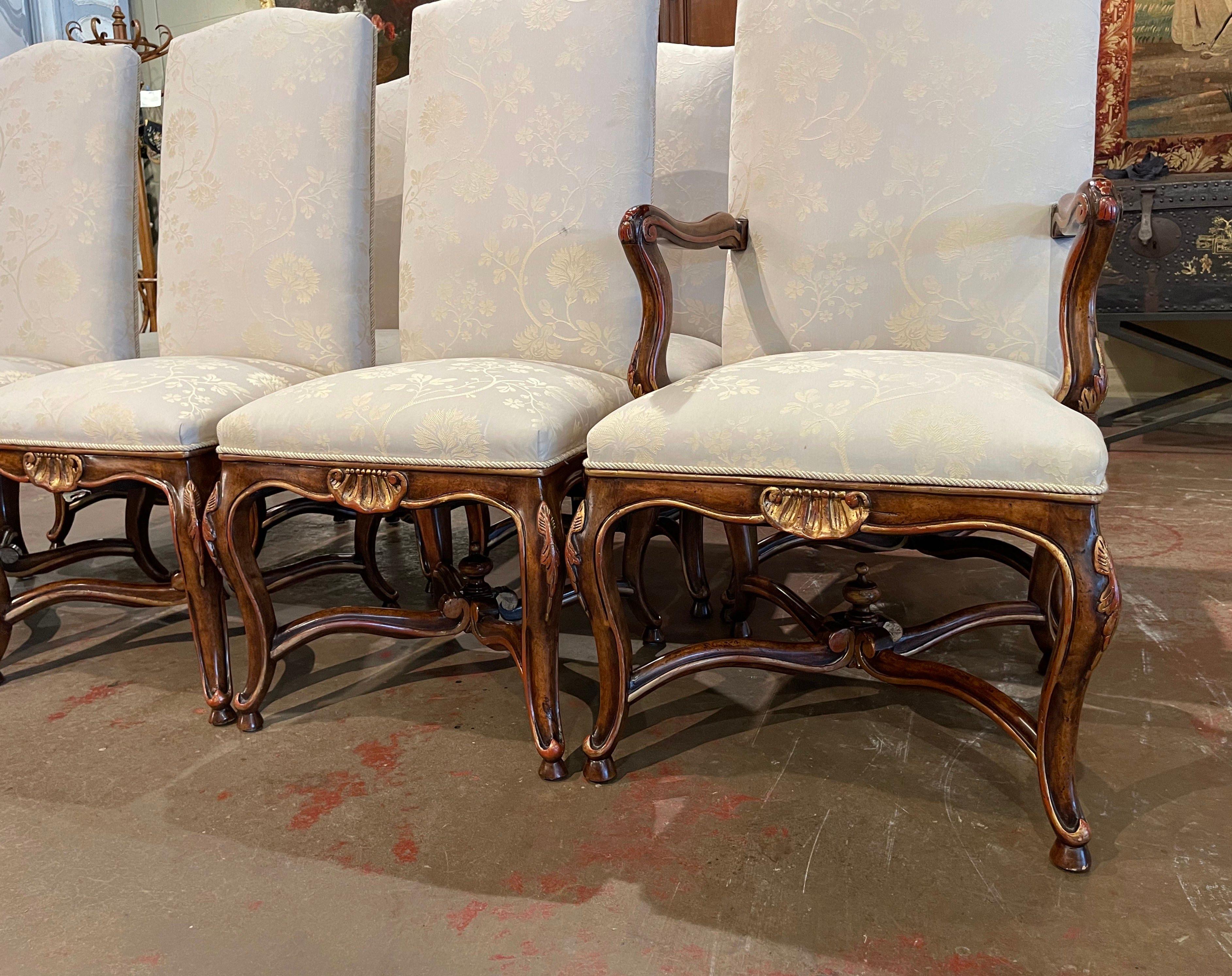 Decorate a dining table with this elegant suite of dining chairs. Crafted by Minton Spidell circa 2000, the set comprises six side chairs and two matching armchairs. Each piece stands on cabriole legs decorated with acanthus leaves at the shoulder