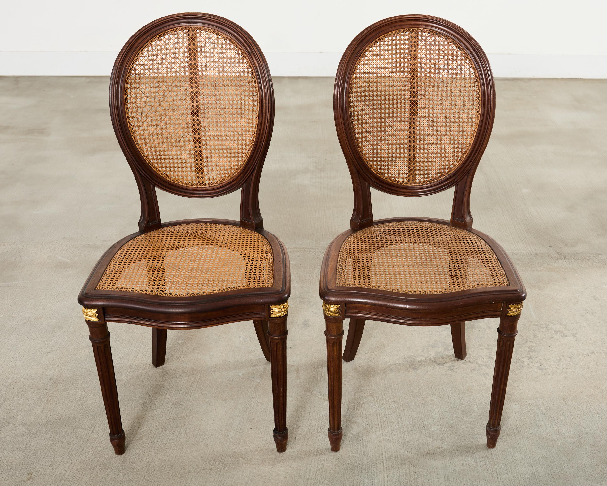 20ième siècle Set of Eight Louis XVI Style Bronze Ormolu Caned Dining Chairs en vente