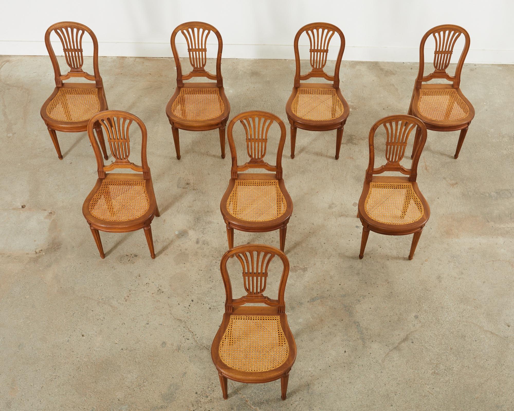 French Set of Eight Louis XVI Style Walnut Cane Dining Chairs For Sale
